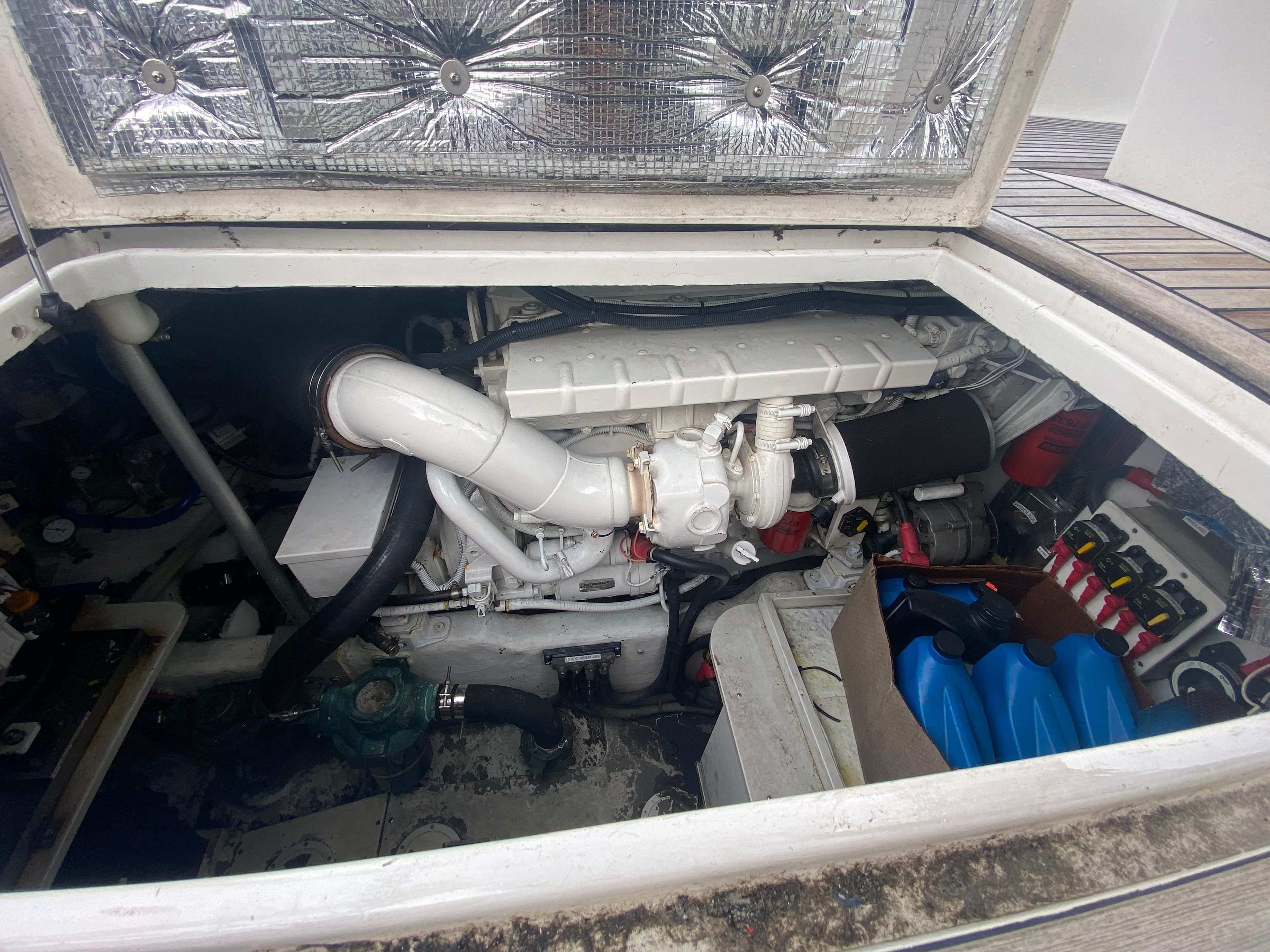 Engine compartment of a 2011 Sabre Custom Yachtfish, showcasing mechanical components and storage.