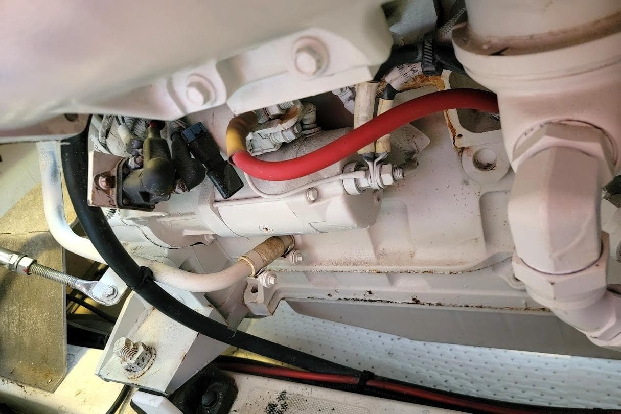 Engine components of a 2014 Prestige 550 yacht, featuring various hoses and connectors.