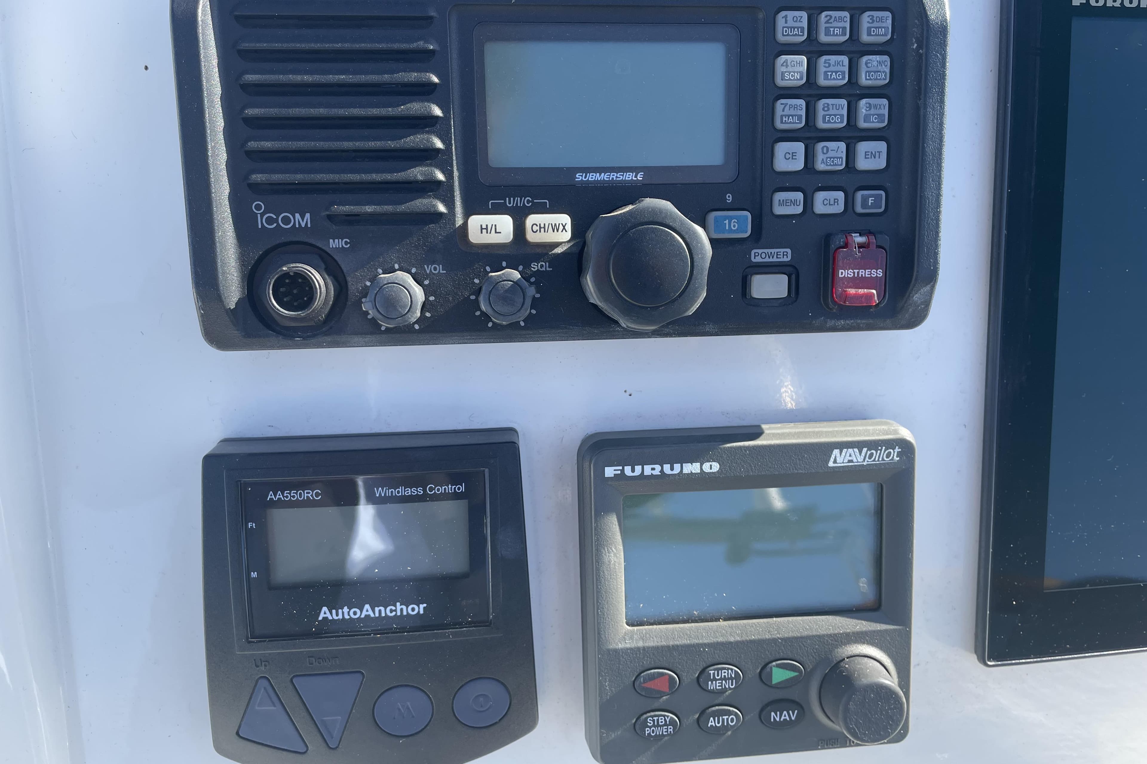 Boat control panel with Icom radio, AutoAnchor, and Furuno NavPilot on 2007 Grand Banks 47 Heritage CL.
