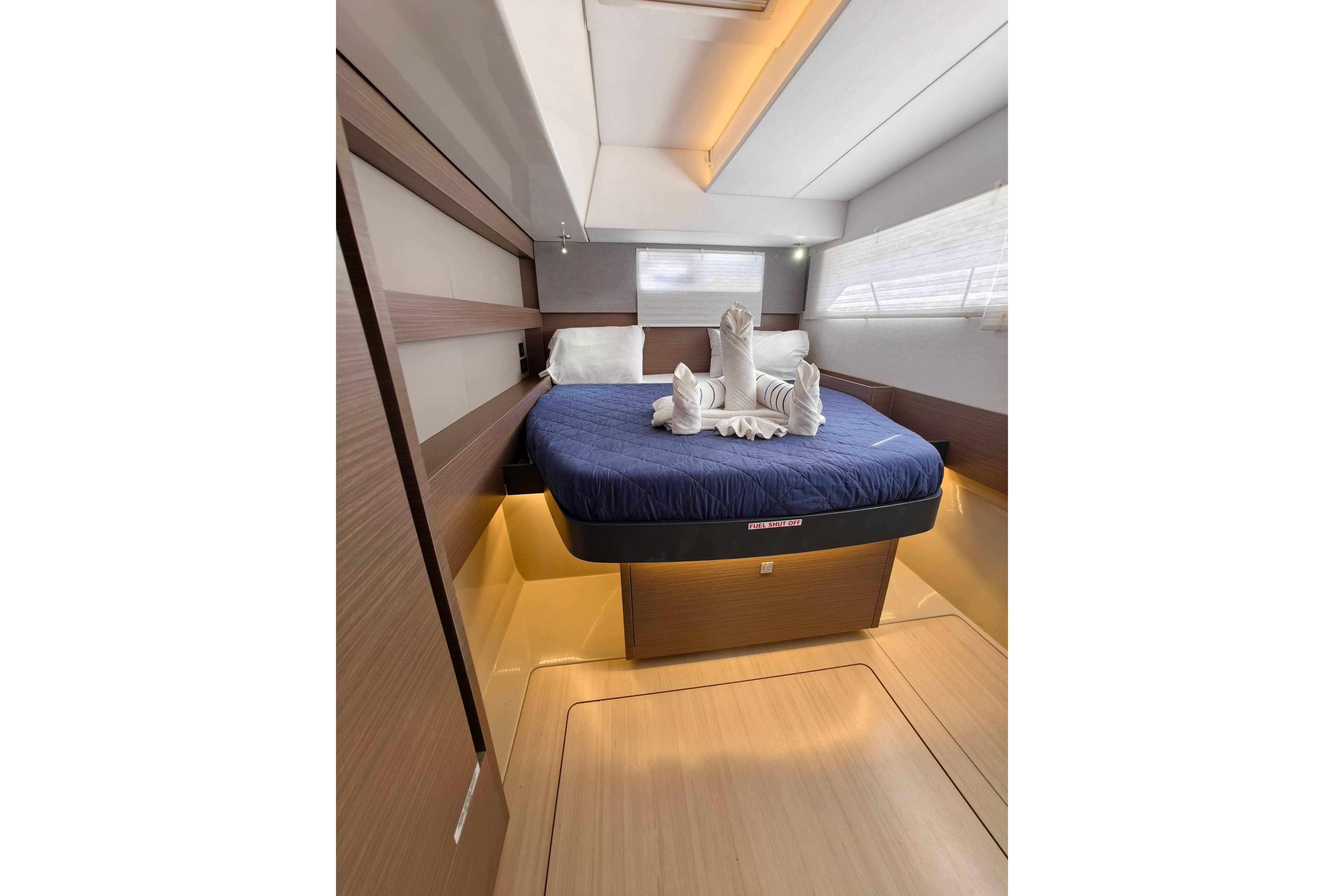 Luxurious bedroom interior of 2021 Leopard 50 yacht with elegant bedding and ambient lighting.
