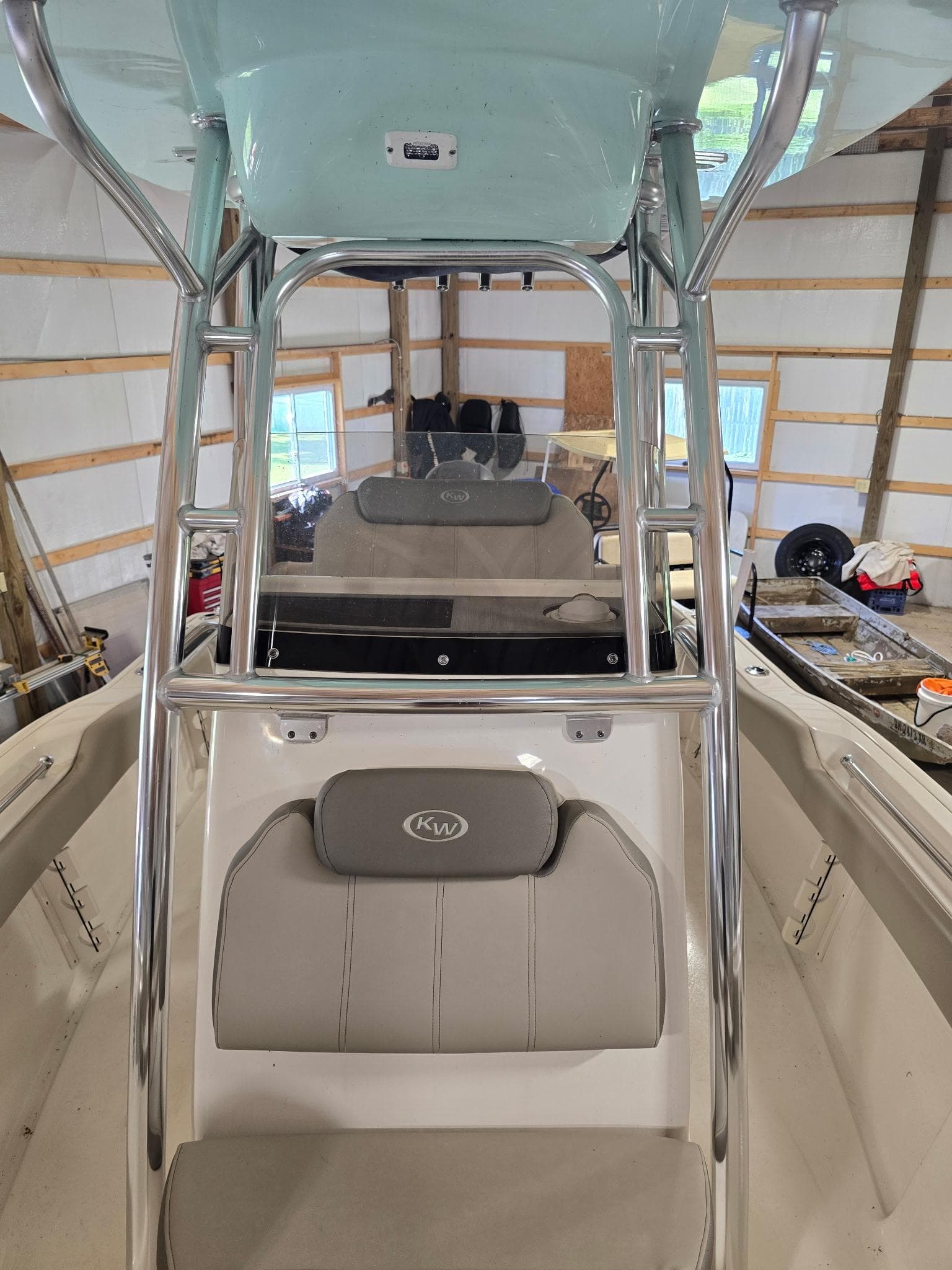 2023 Key West 219 FS boat interior with seating and console in a garage.