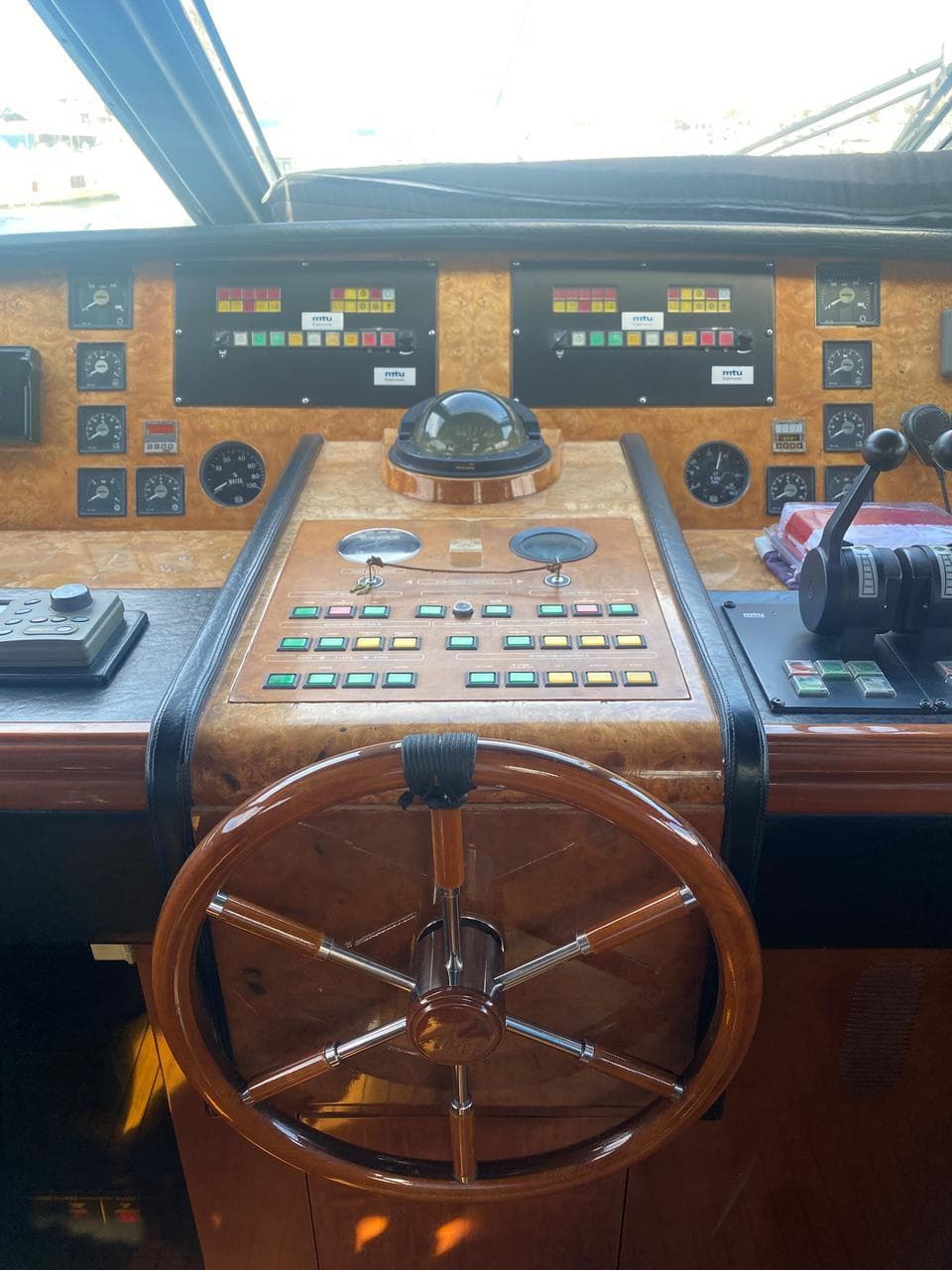Cockpit of 1998 Azimut 90/100 Jumbo Motoryacht with steering wheel and control panels.