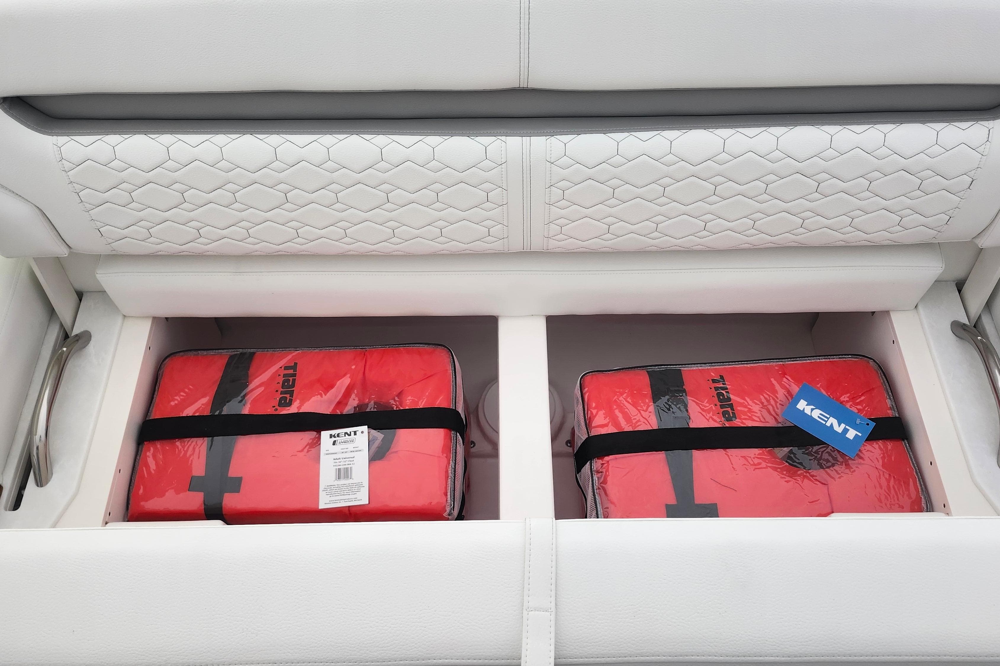 Storage compartment on 2026 Tiara Yachts 34 LS with red life jackets.