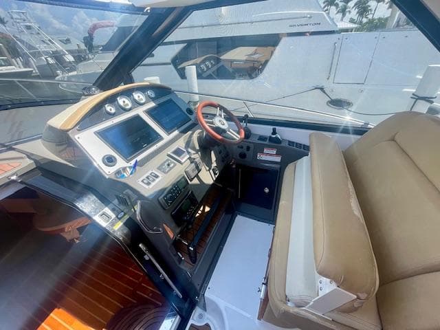 2011 Regal 46 Sport Coupe helm with modern controls and beige seating.