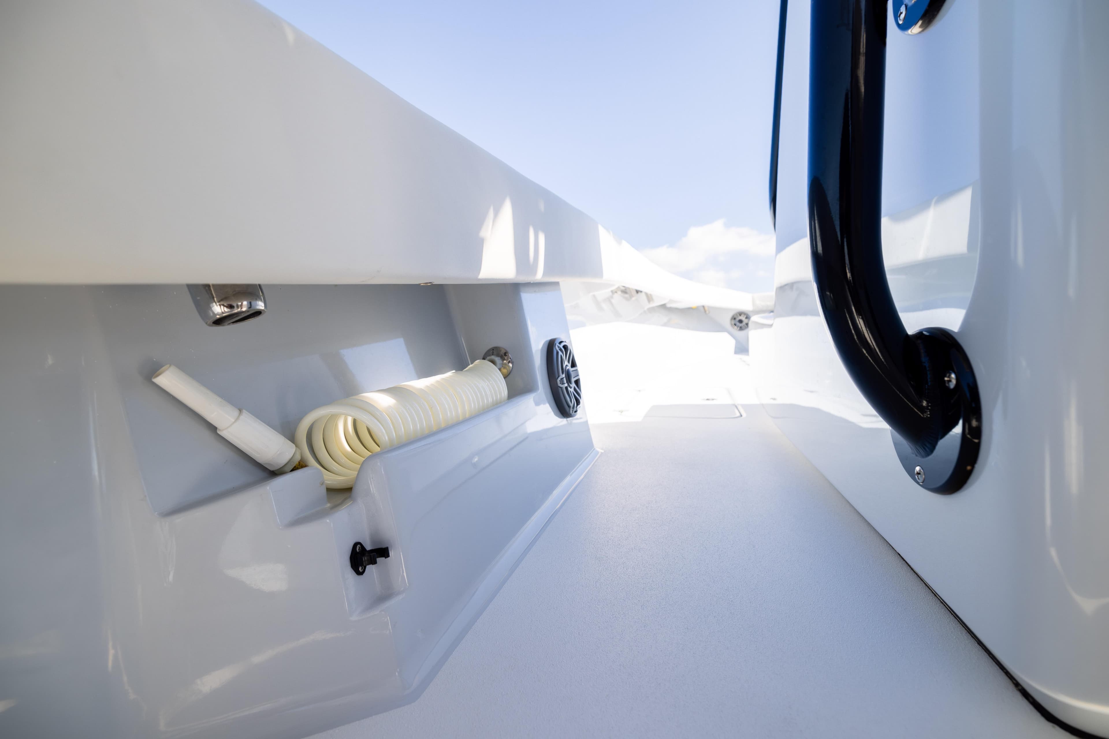 Interior view of 2025 Conch 33 boat, featuring storage compartment and handle.