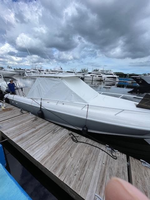 2008 Intrepid Cuddy boat docked under cloudy skies.