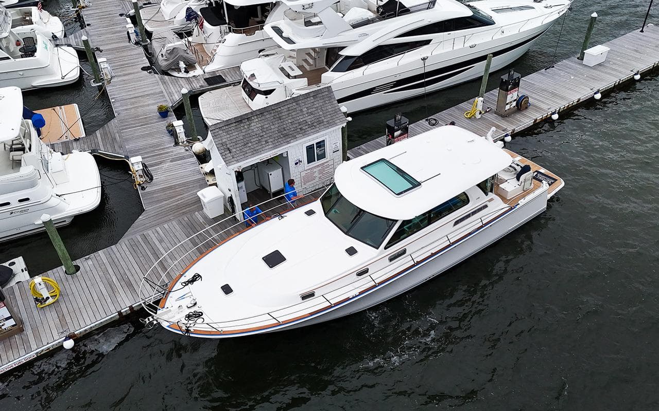 2026 Sabre 45 Salon Express yacht docked at marina, aerial view.
