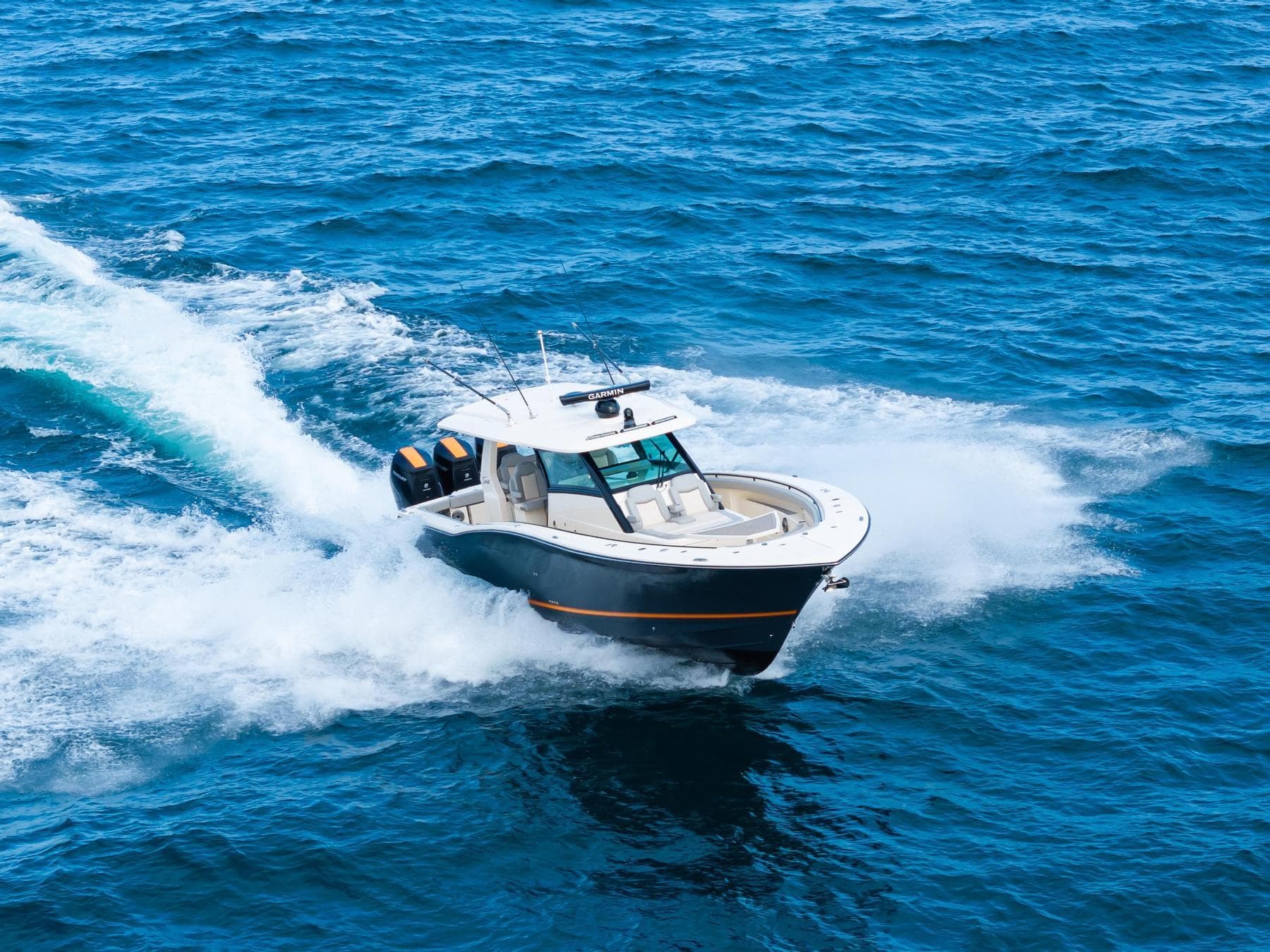 2023 Scout 425 LXF boat cruising on open blue ocean waters.