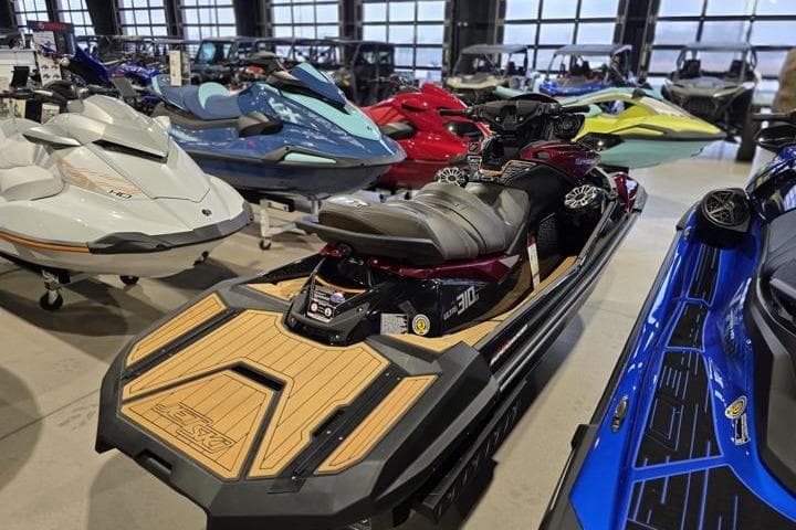 2026 Kawasaki Jetski Ultra 310LX in showroom, surrounded by various personal watercraft models.