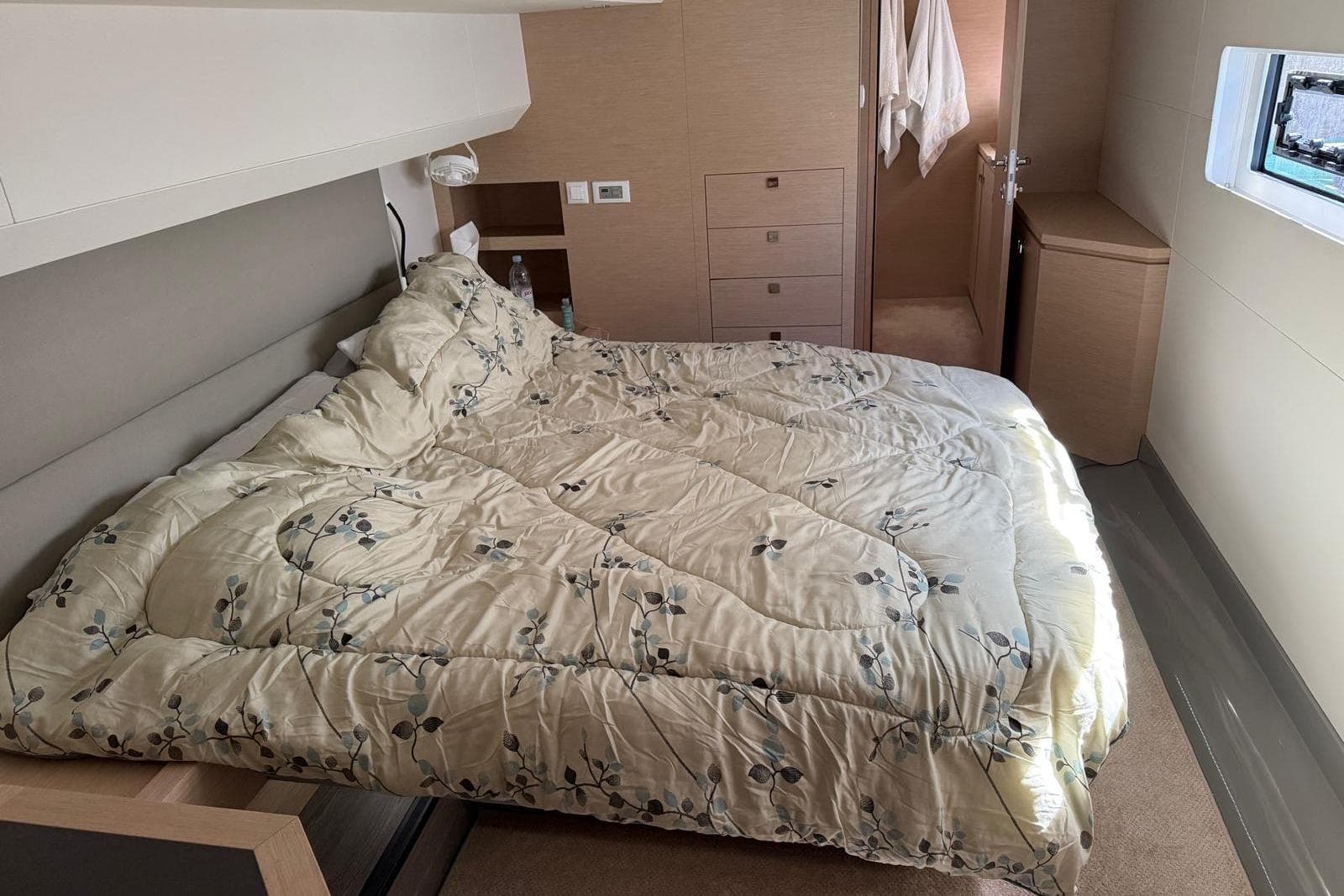 Luxurious bedroom interior of 2021 Fountaine Pajot Motor Yacht 44 with cozy bedding.