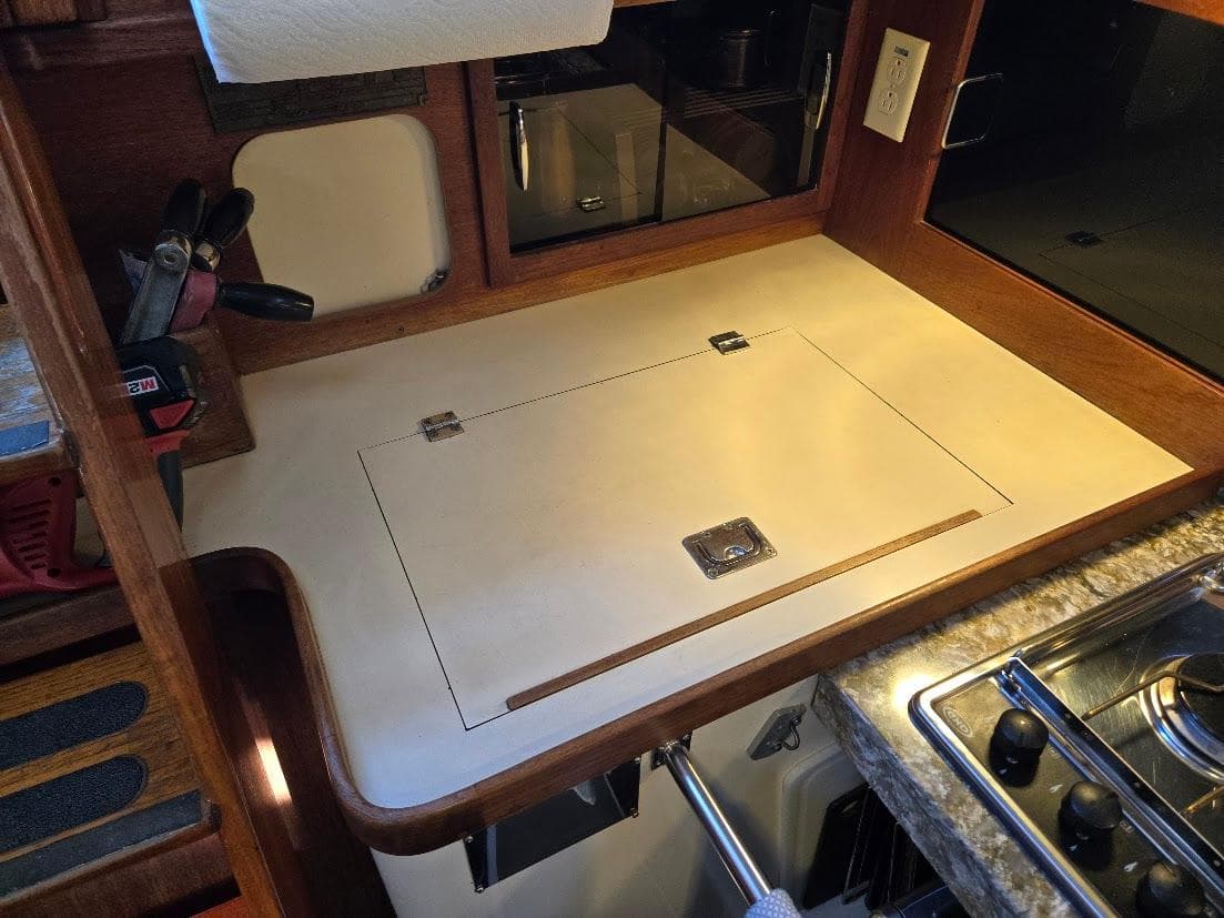 1991 Freedom F-38 yacht kitchen with wooden countertop and built-in stove.