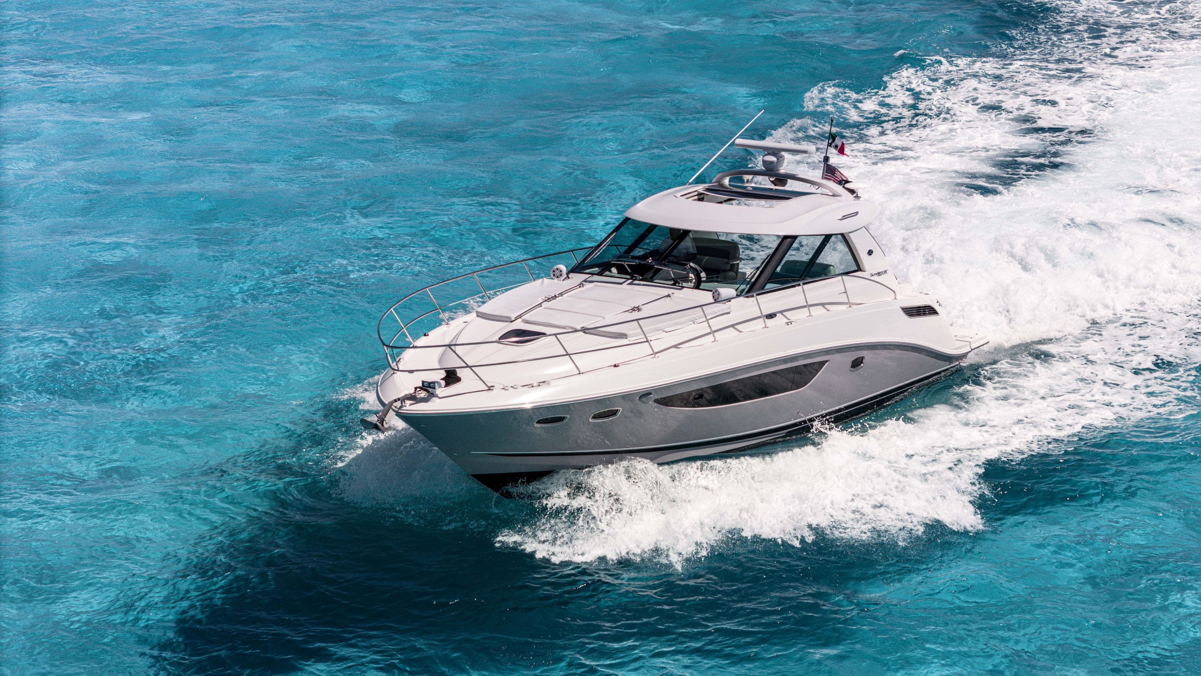 2013 Sea Ray 450 Sundancer cruising on clear blue ocean waters.