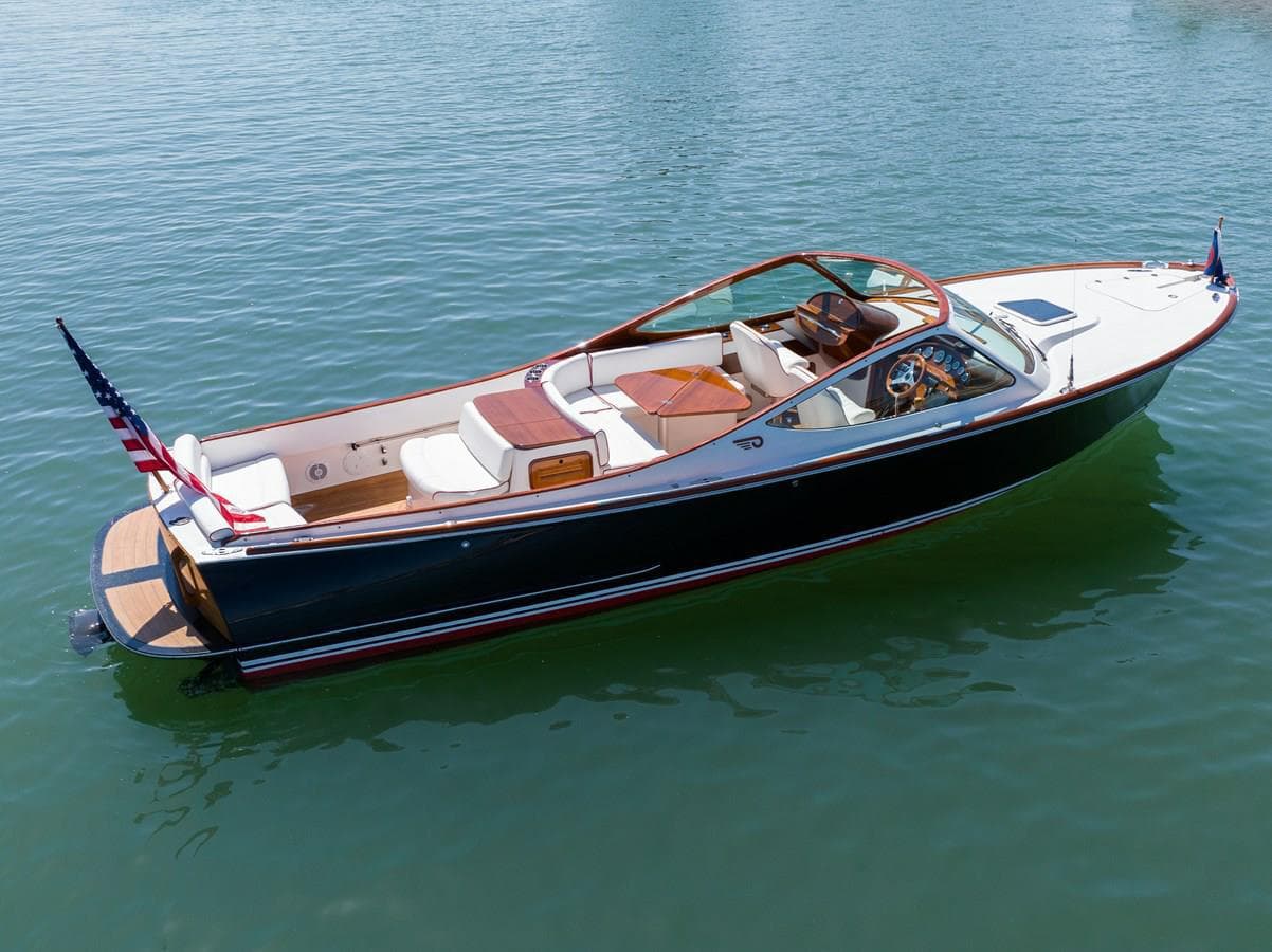 2007 Hinckley Talaria 29 R boat on calm water, featuring sleek design and American flags.