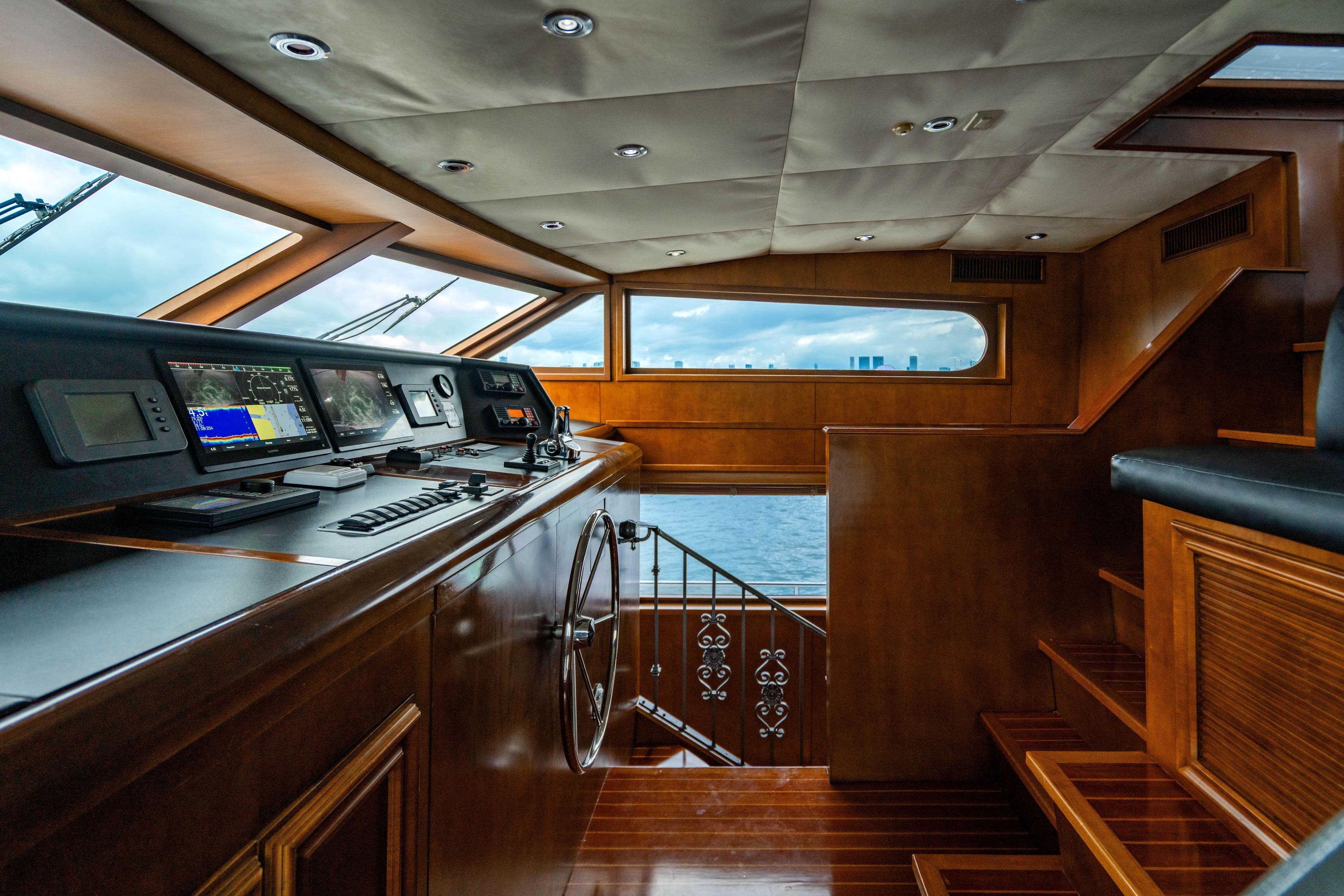Luxurious 2006 Broward Raised Pilothouse yacht interior with navigation equipment and ocean view.