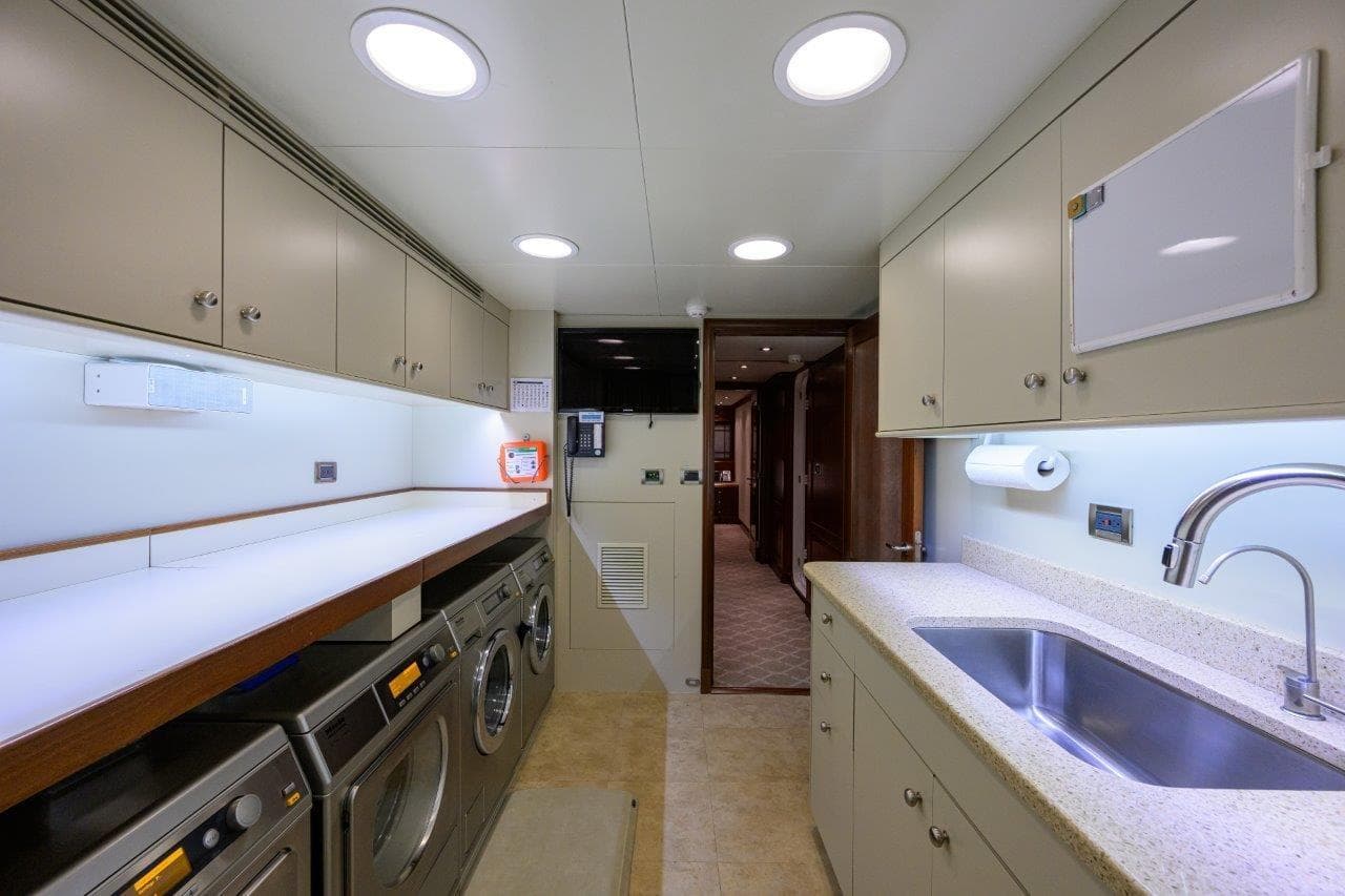 Laundry and utility room in 2011 C & G Boatworks Explorer yacht, featuring modern appliances.