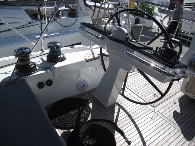 Cockpit of 2025 Jeanneau Yacht 65 with steering wheel and winches.