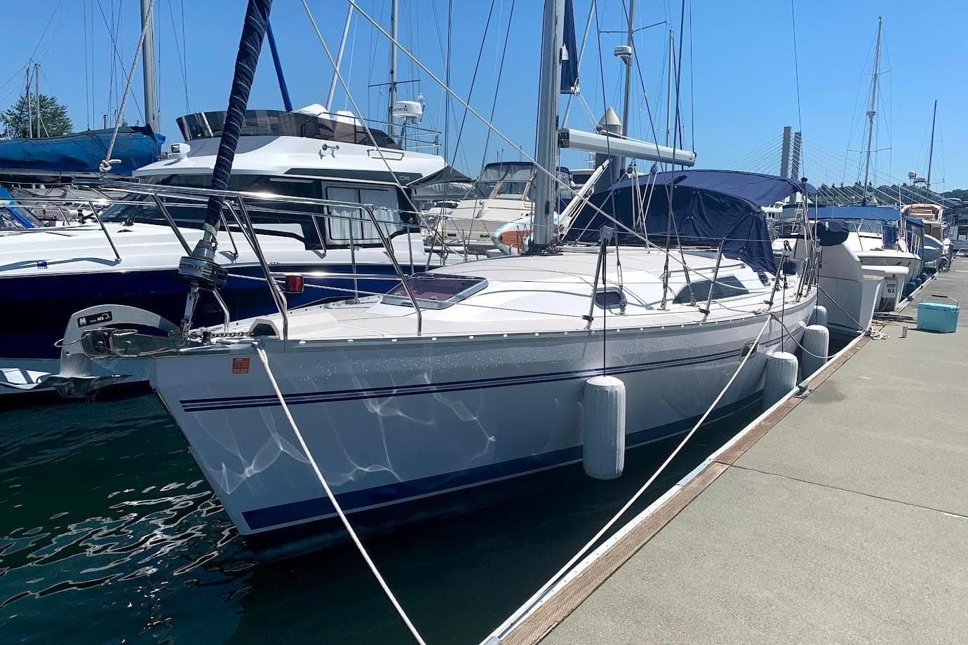 Sailboat Catalina 355, 2012 model, docked at marina under clear blue sky.