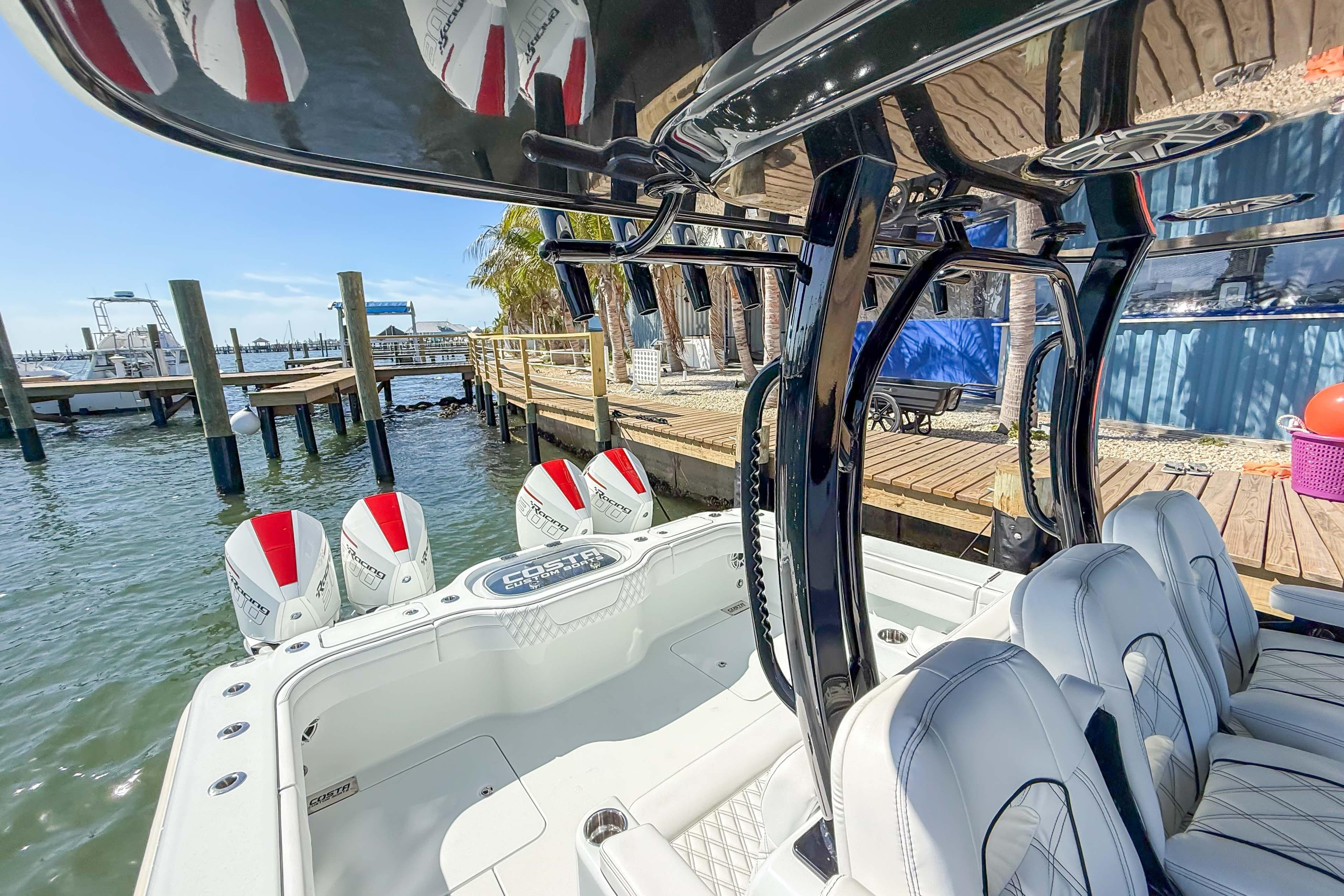 2023 Costa Custom Boats 34 model docked, showcasing sleek design and powerful engines.