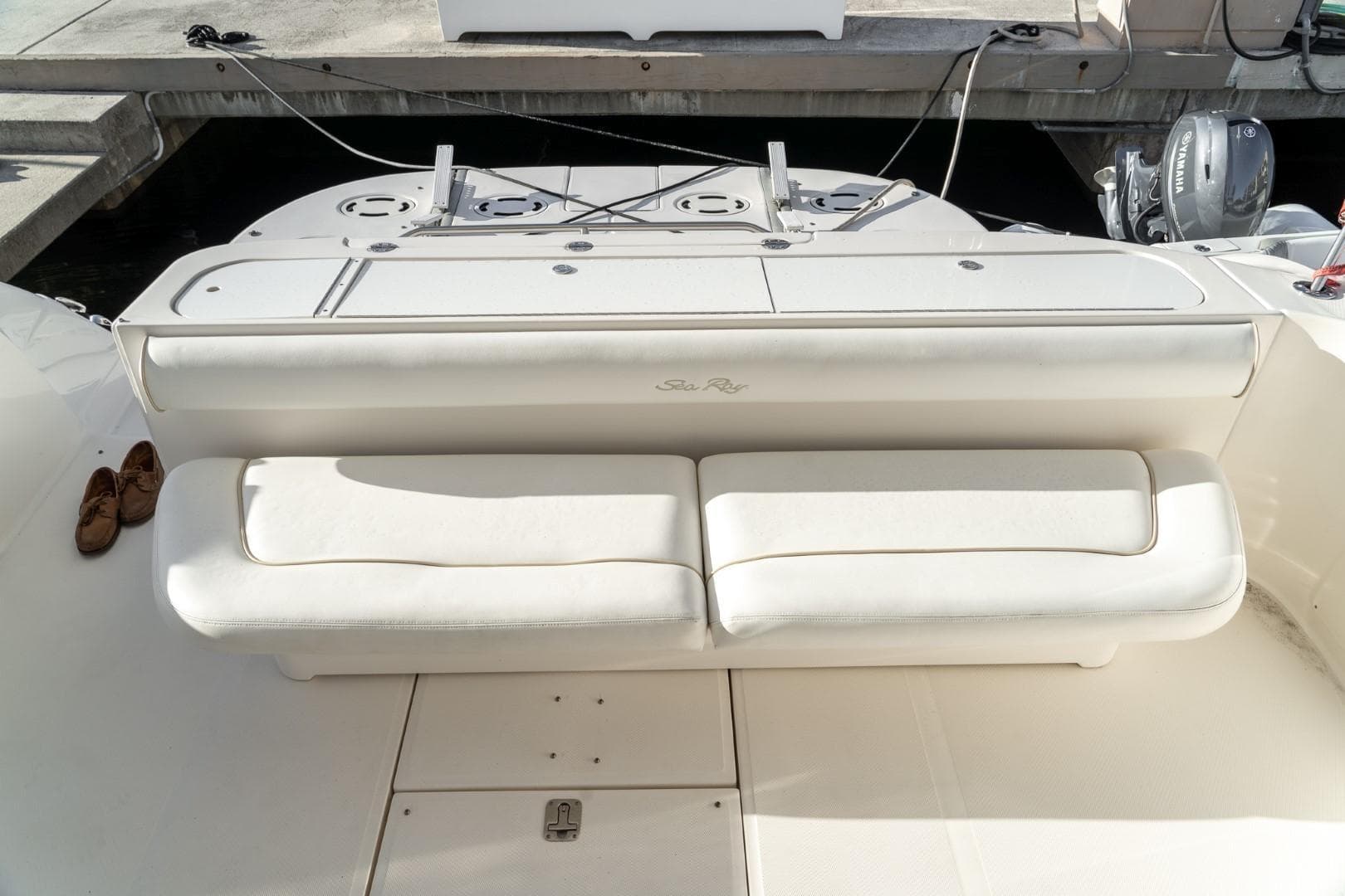 2008 Sea Ray 58 Sedan Bridge yacht with white seating and docked in marina.