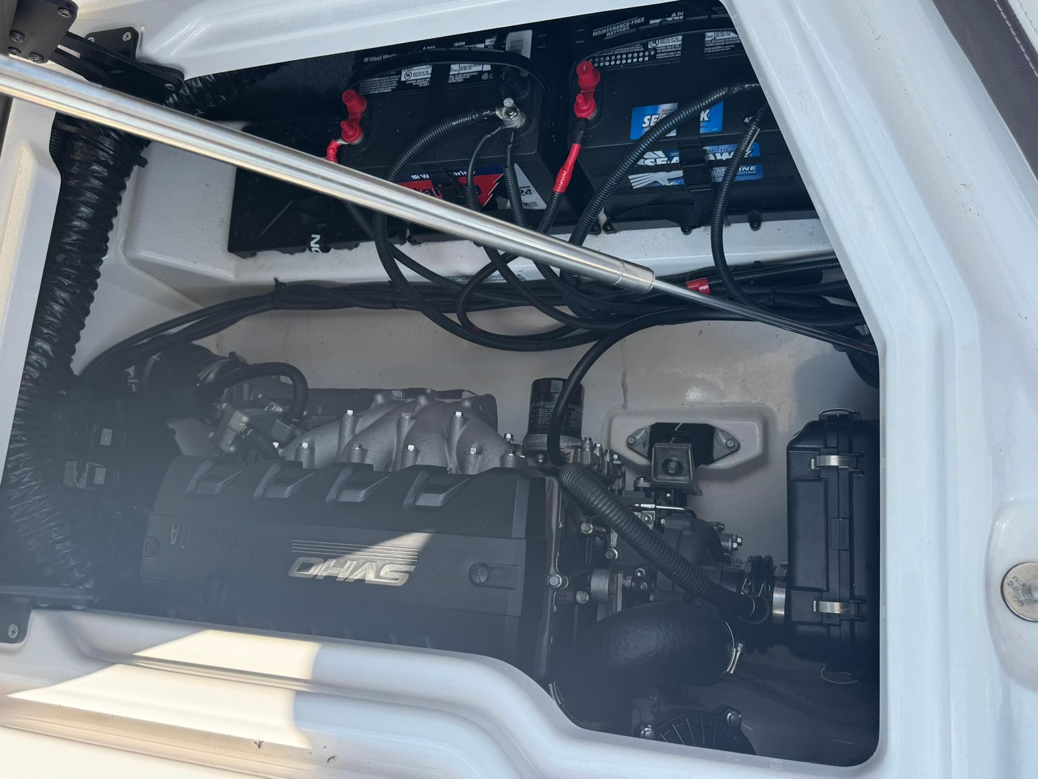Engine compartment of a 2022 Yamaha Boats 275SD, showcasing internal components and wiring.