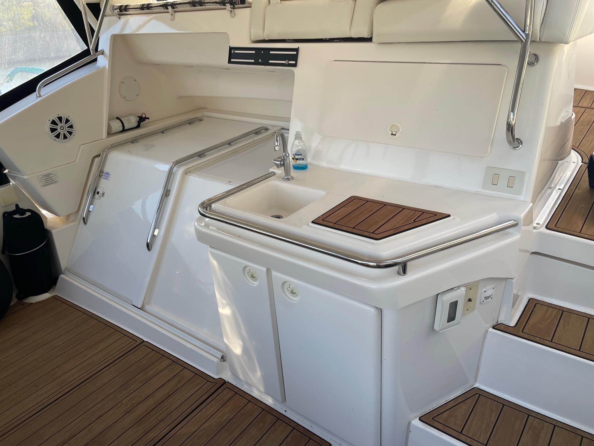 1999 Silverton 392 Motor Yacht interior with sink, storage, and wooden flooring.