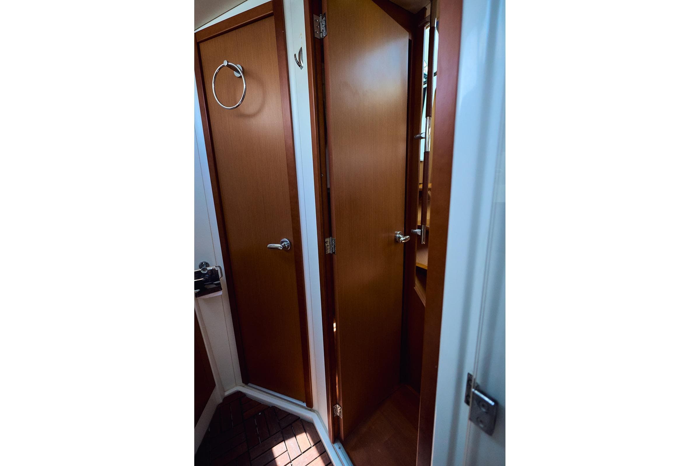 Interior view of 2014 Beneteau Oceanis 48 yacht showing wooden doors and fixtures.