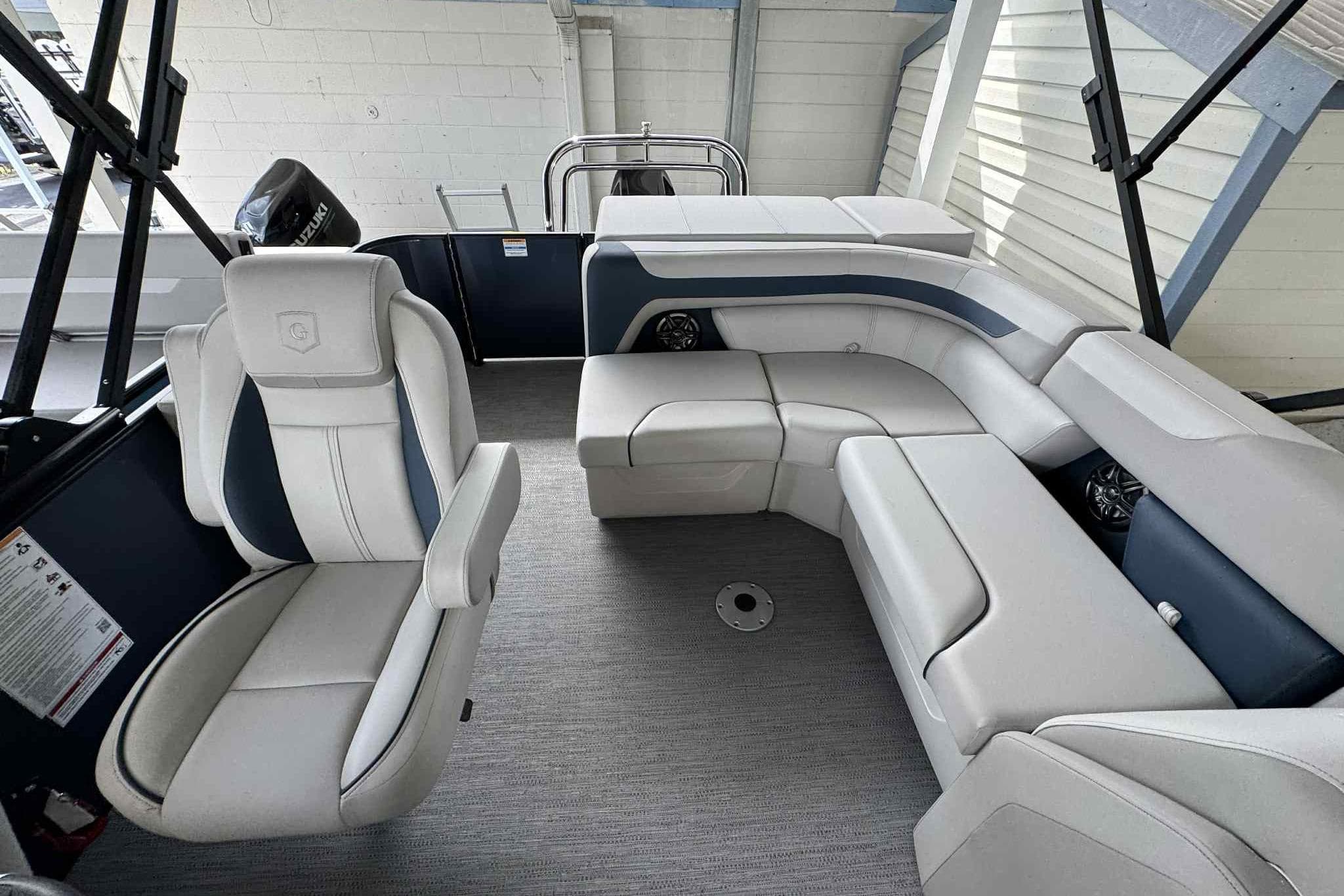 Interior of 2025 Sweetwater 2086 CSE boat with modern seating and sleek design.