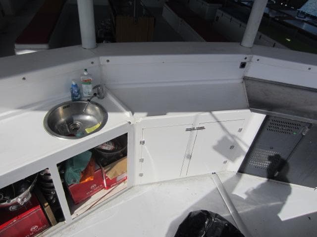 2011 Catamaran H2X Maxi Day Charter Cat kitchen area with sink and storage.