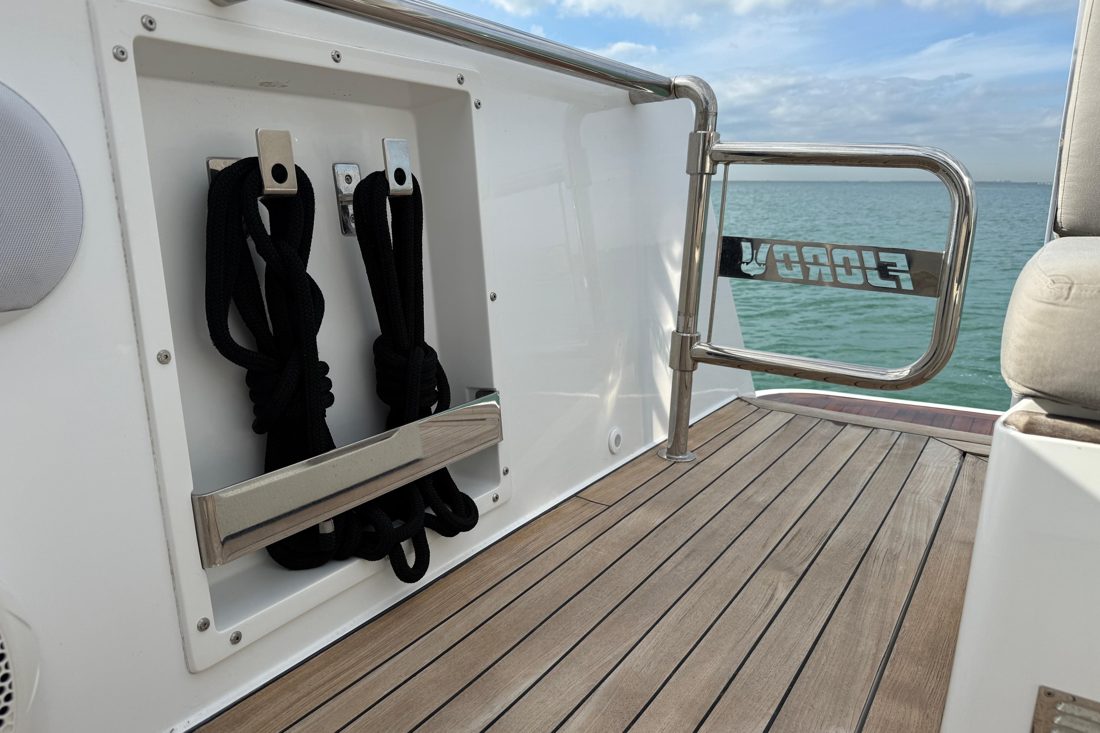 2019 Fjord 40' Open yacht deck with wooden flooring and rope storage.