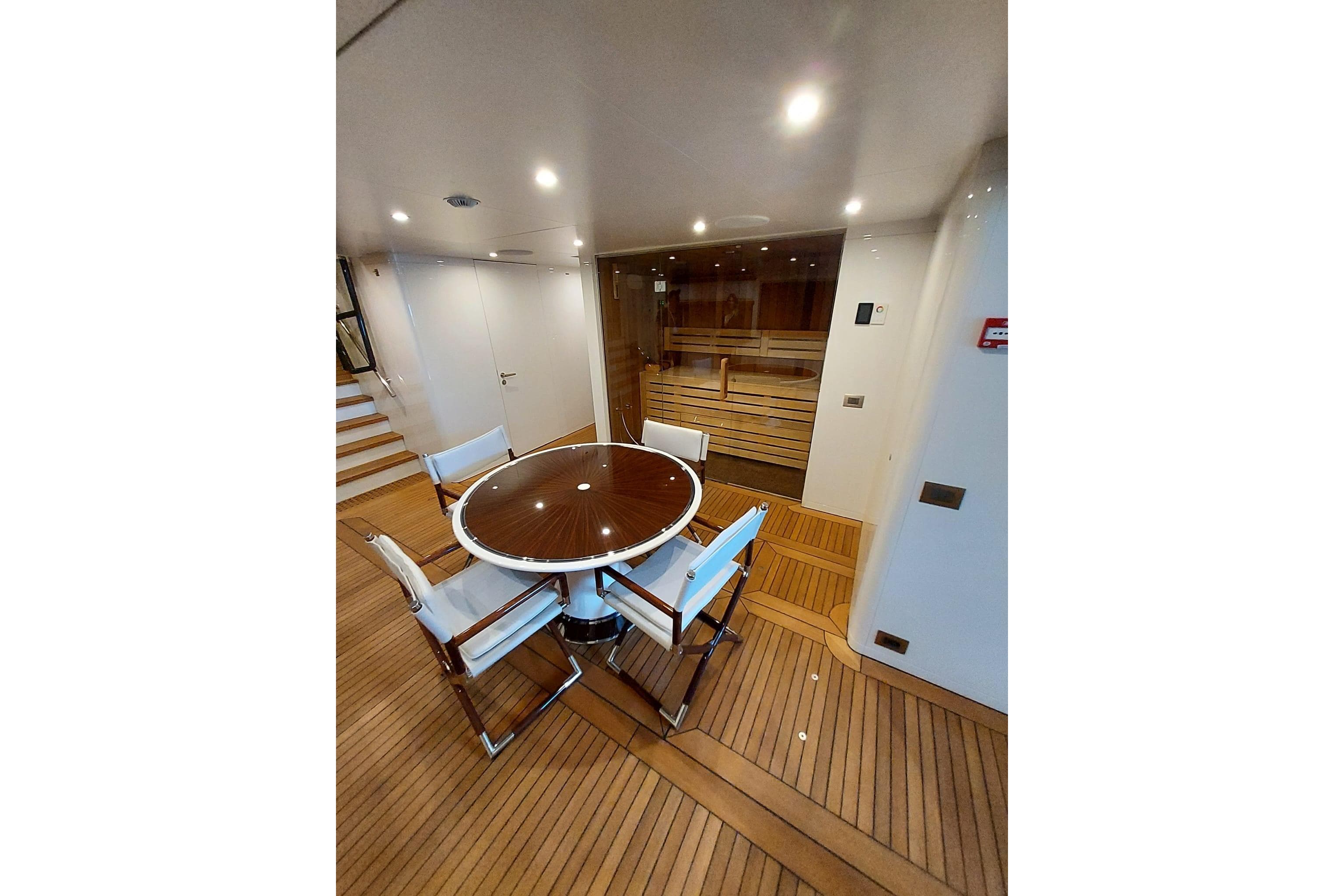 Luxurious Benetti B.NOW 2022 yacht interior with elegant dining area and wooden flooring.