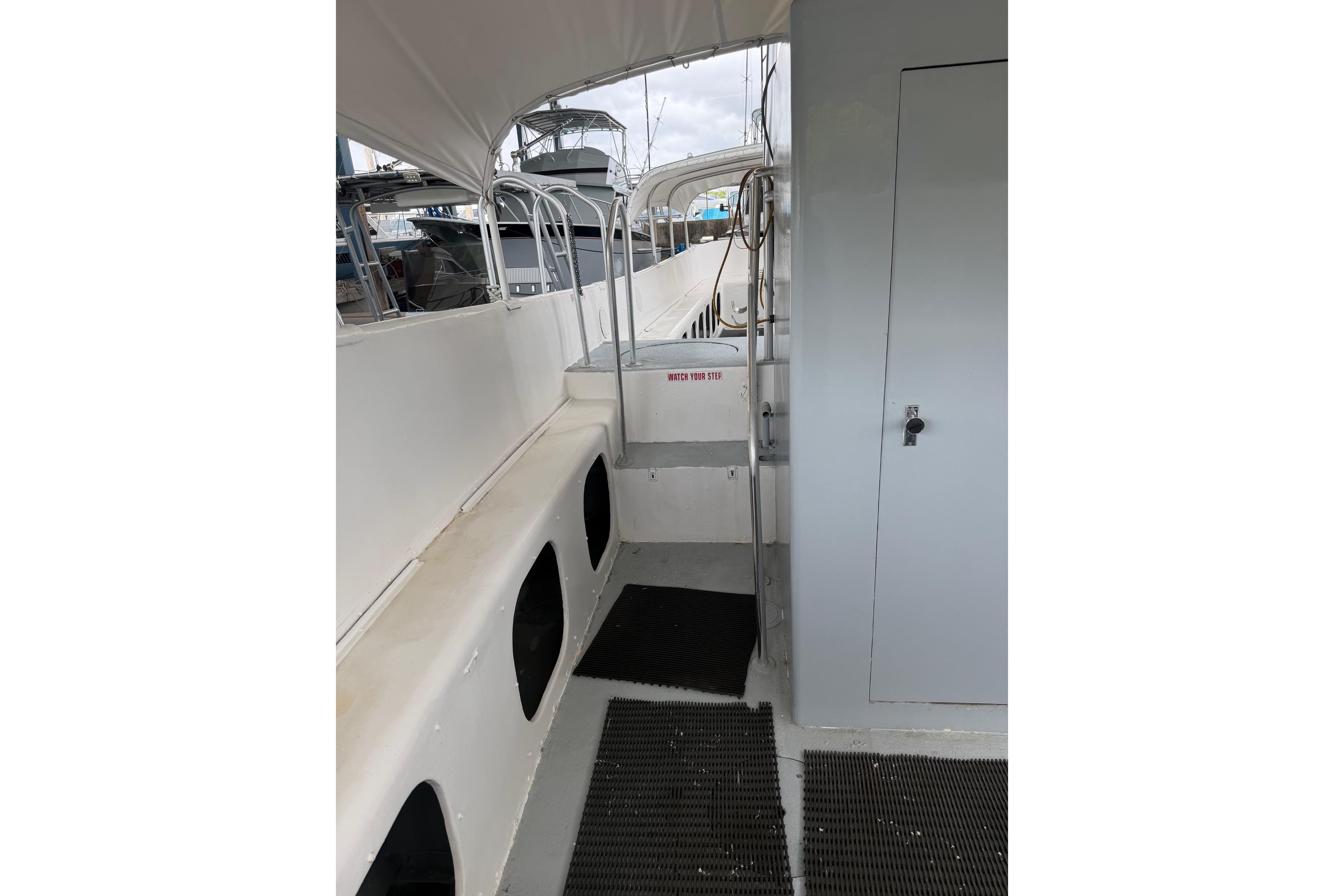 1979 Willard Marine 50 Utility Launch interior with white seating and metal railings.