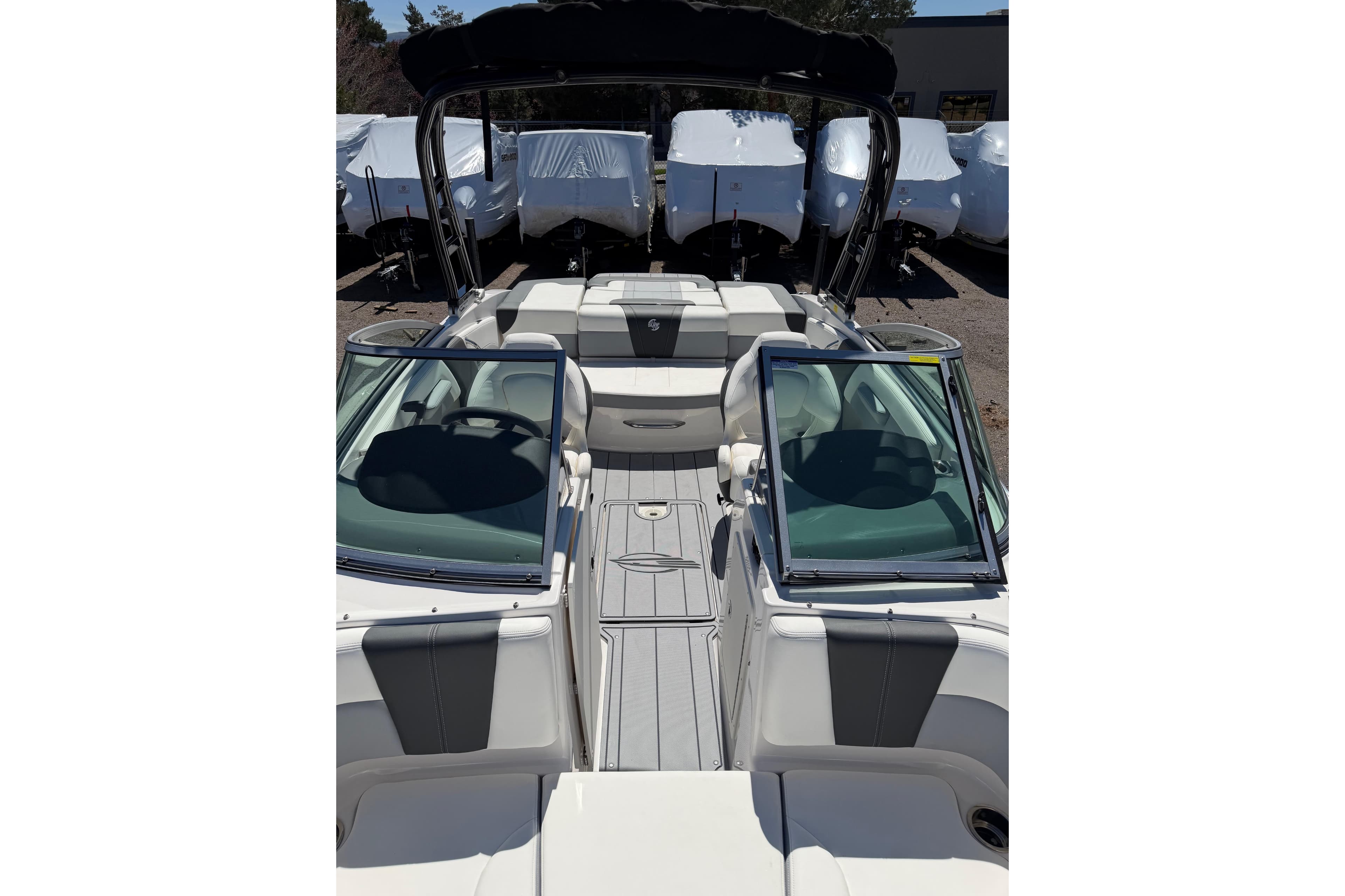 2023 Chaparral 21 Surf boat interior with open windshield and seating area.