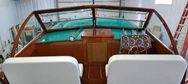 1961 Chris-Craft Roamer boat interior with vintage dashboard and white seats.