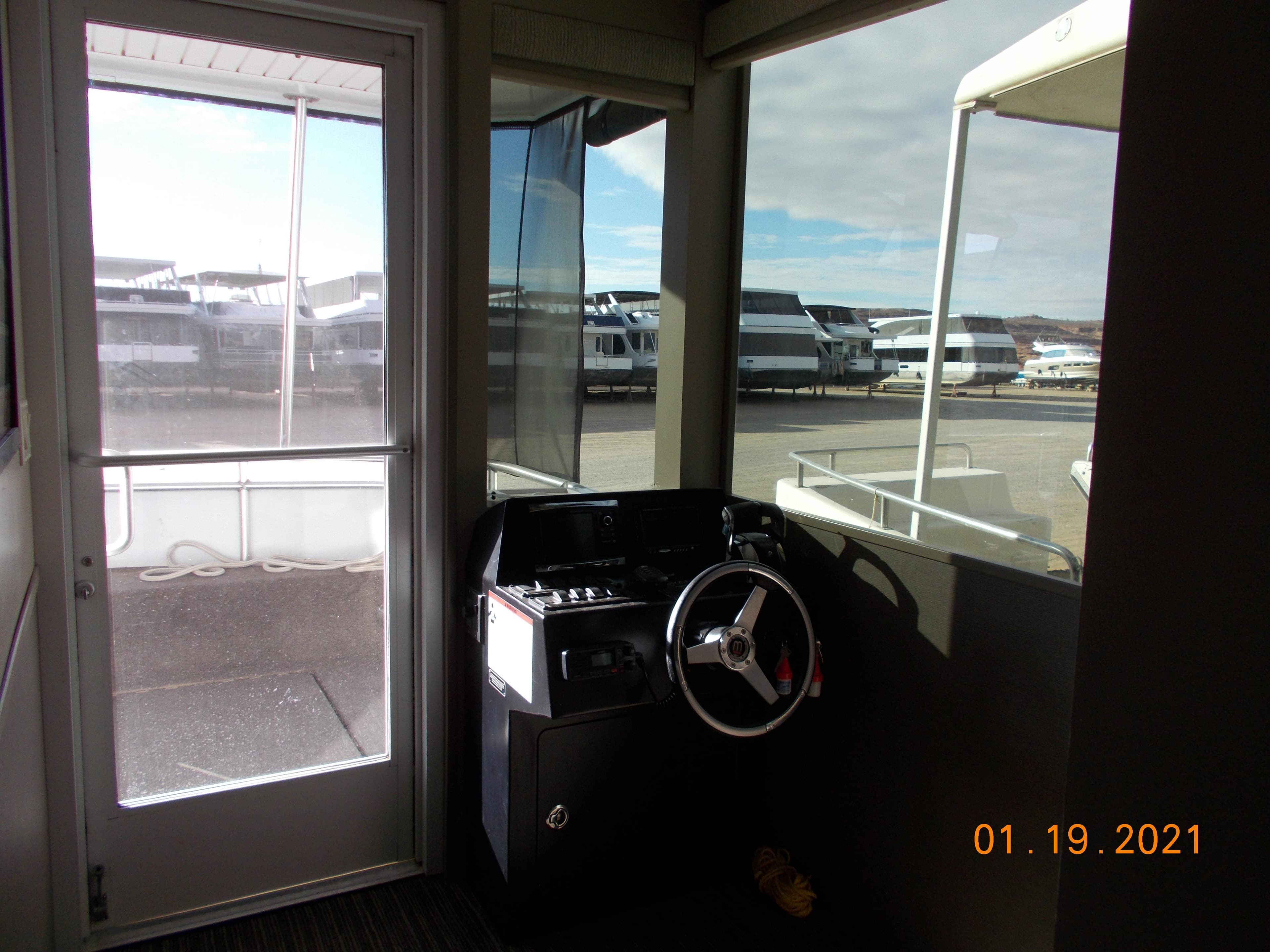 Bravada houseboat helm station in marina, 2021.