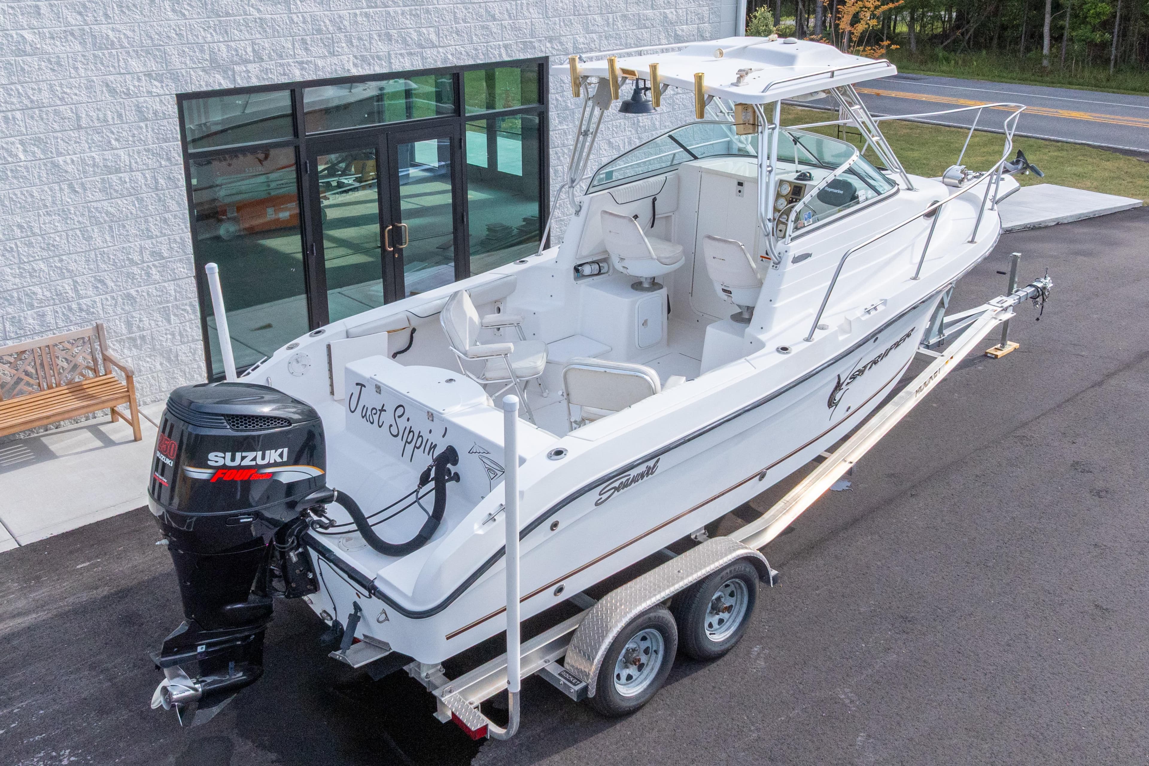 2007 Seaswirl Striper 2301 Walkaround OB boat with Suzuki outboard motor on trailer.