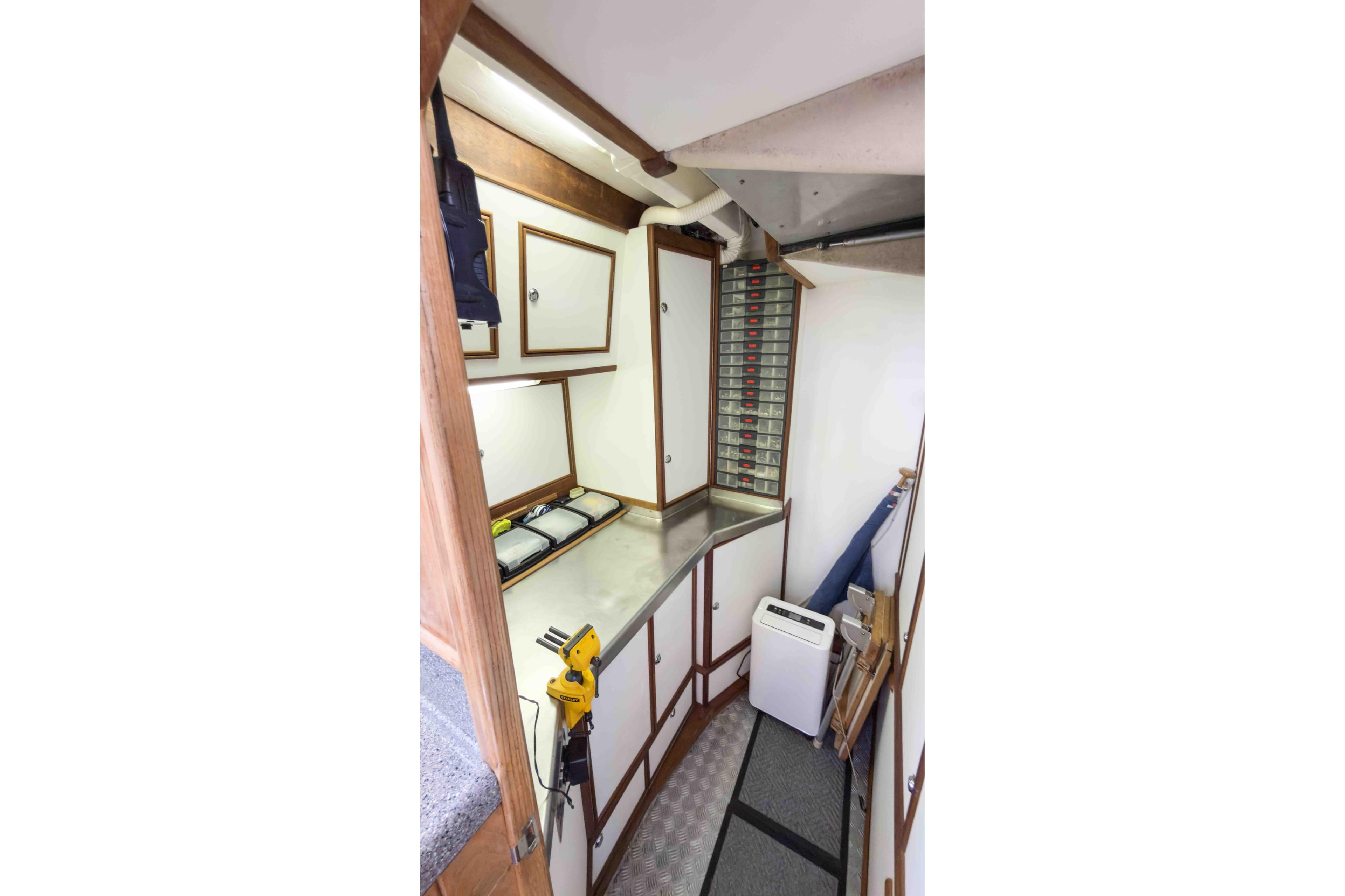 Interior of a 1994 Callisto 465 boat with storage and workbench area.
