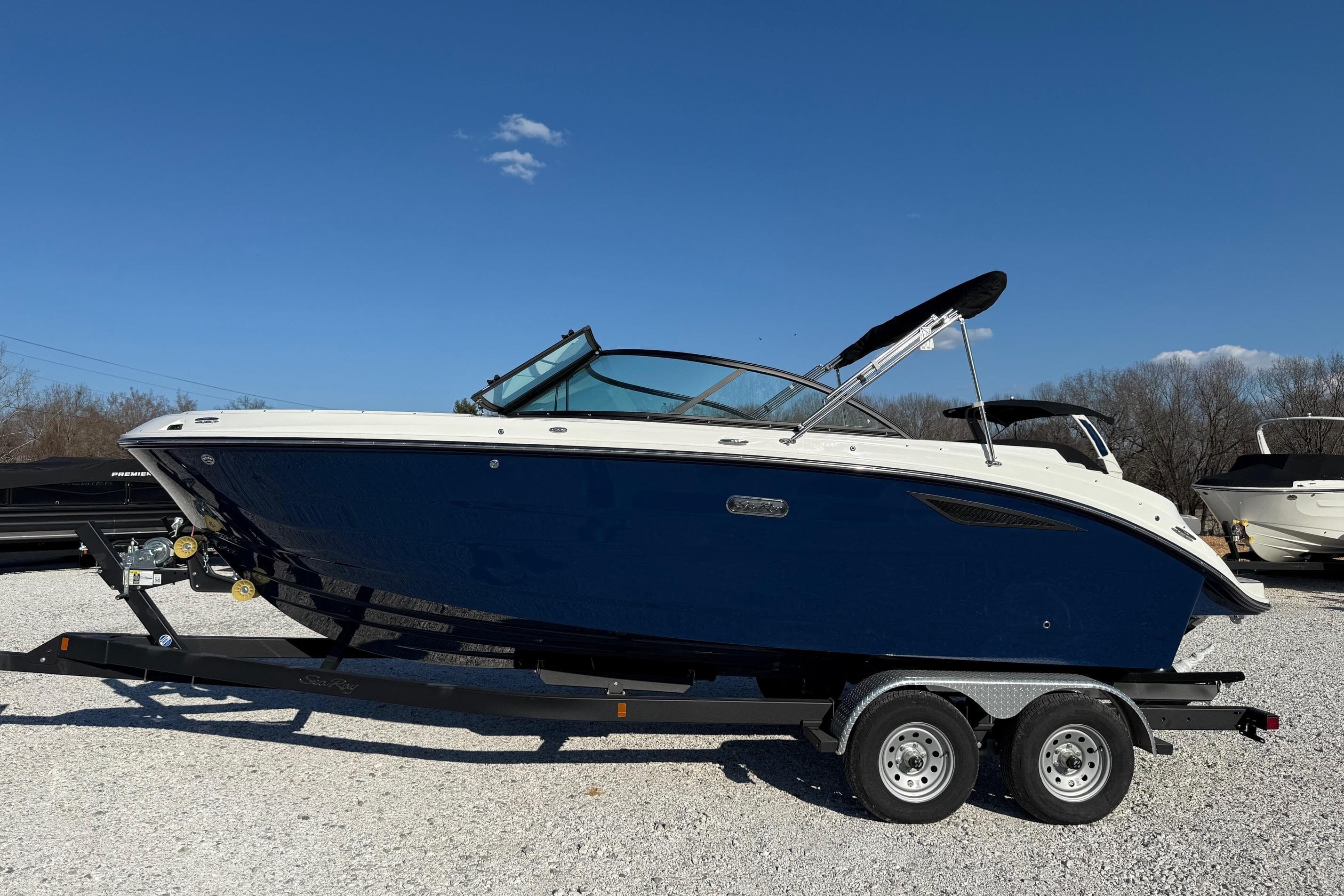 2026 Sea Ray SDX 230 boat on trailer under clear blue sky.