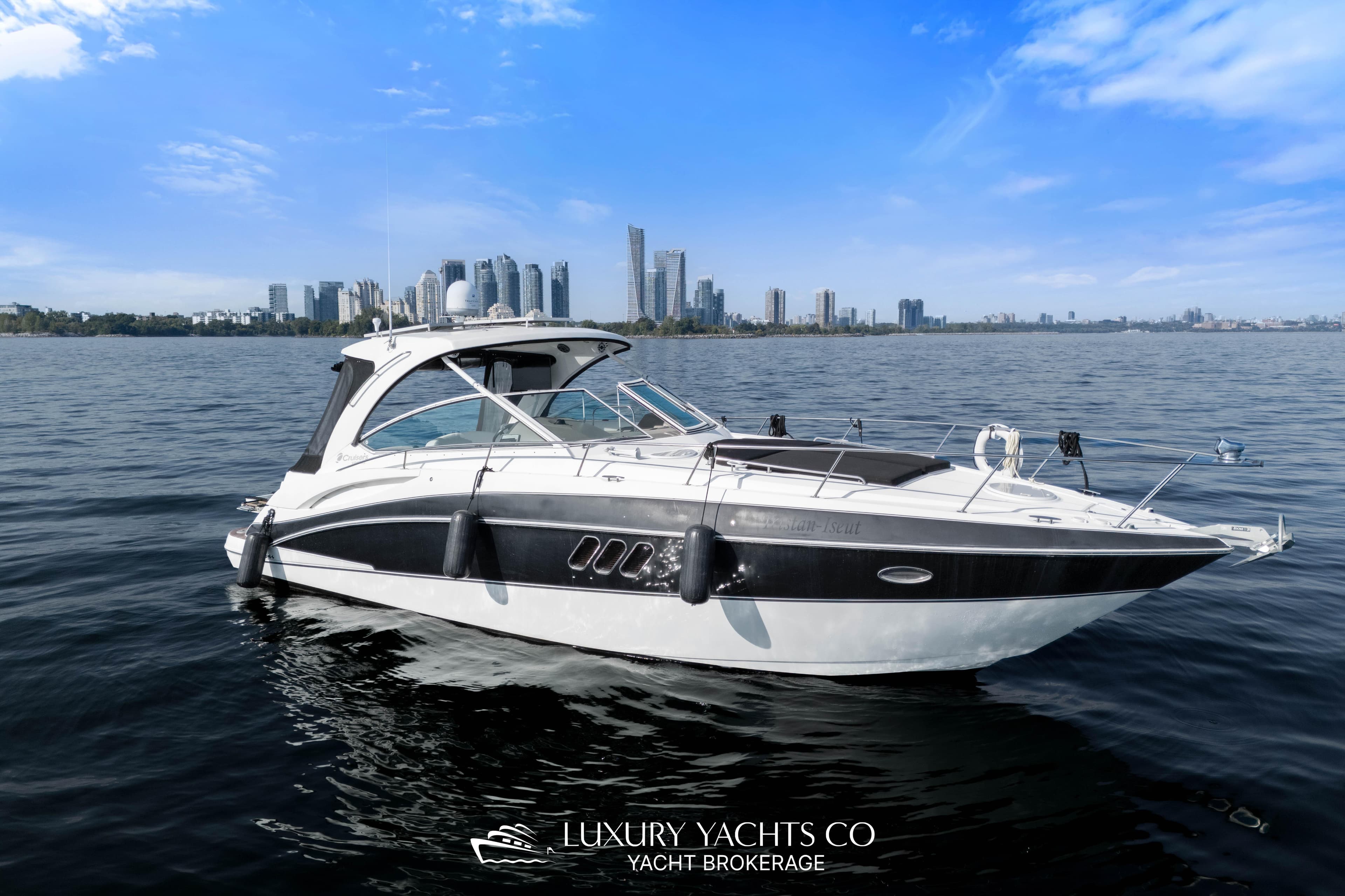 2009 Cruisers Yachts 360 Express on water with city skyline in background.