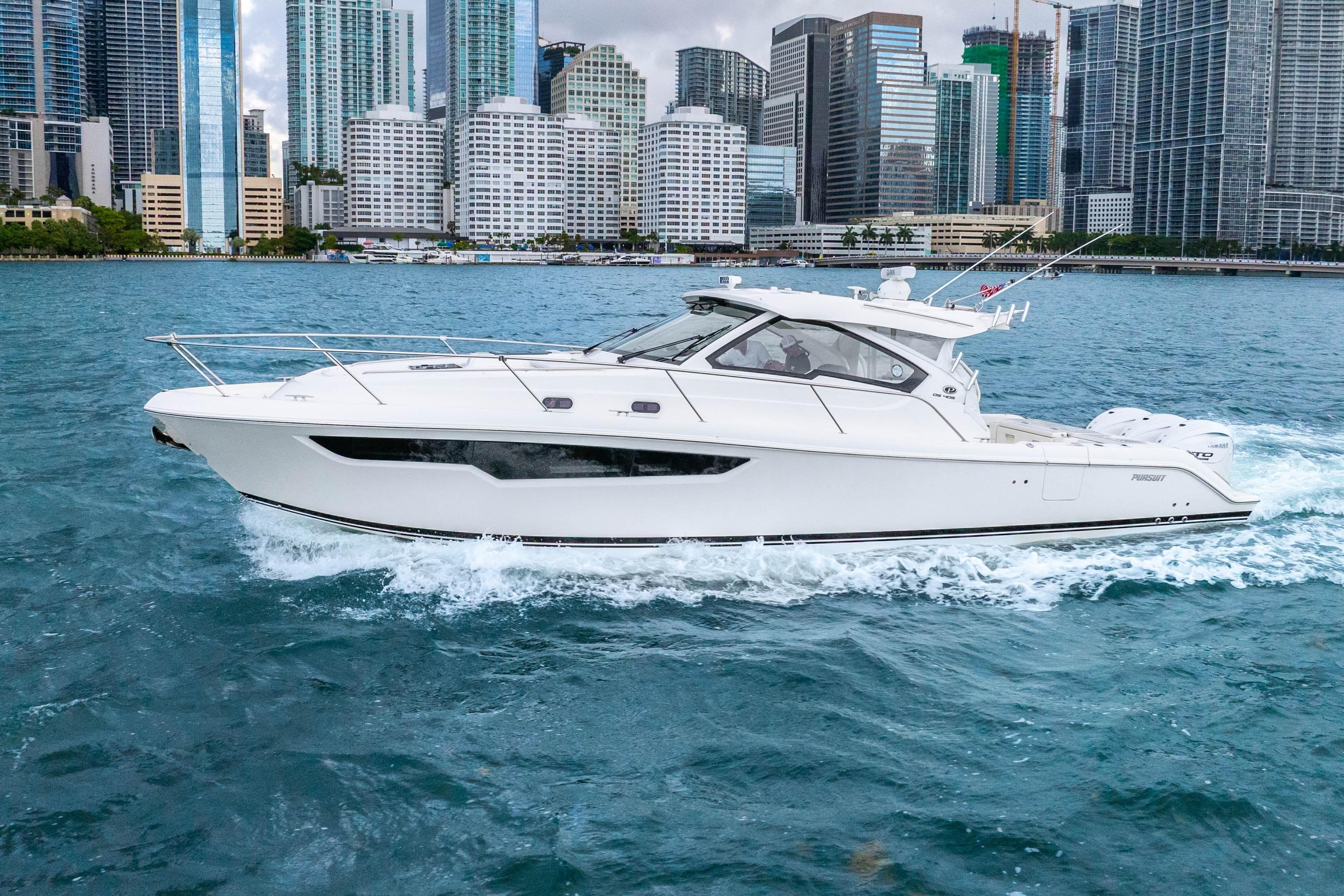 2026 Pursuit OS 405 Offshore yacht cruising near city skyline.