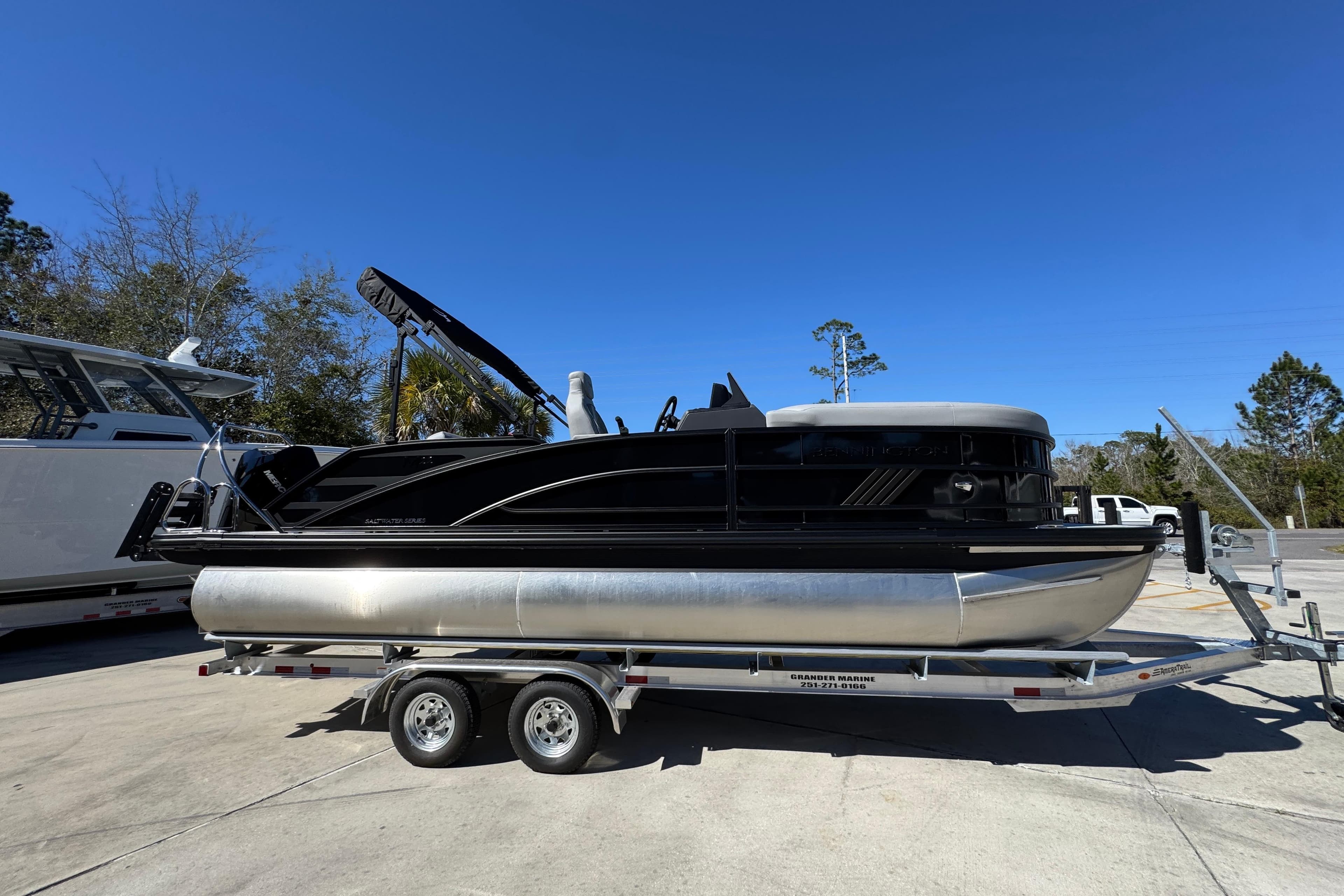 2026 Bennington 22 MSB pontoon boat on trailer under clear blue sky.