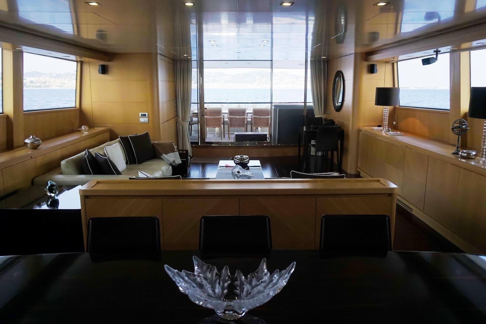 Luxurious interior of 2007 Sanlorenzo SL108 yacht with elegant seating and sea view.
