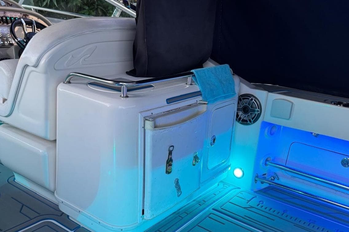 2006 Sea Ray 290 Amberjack interior with blue LED lighting and cockpit seating.