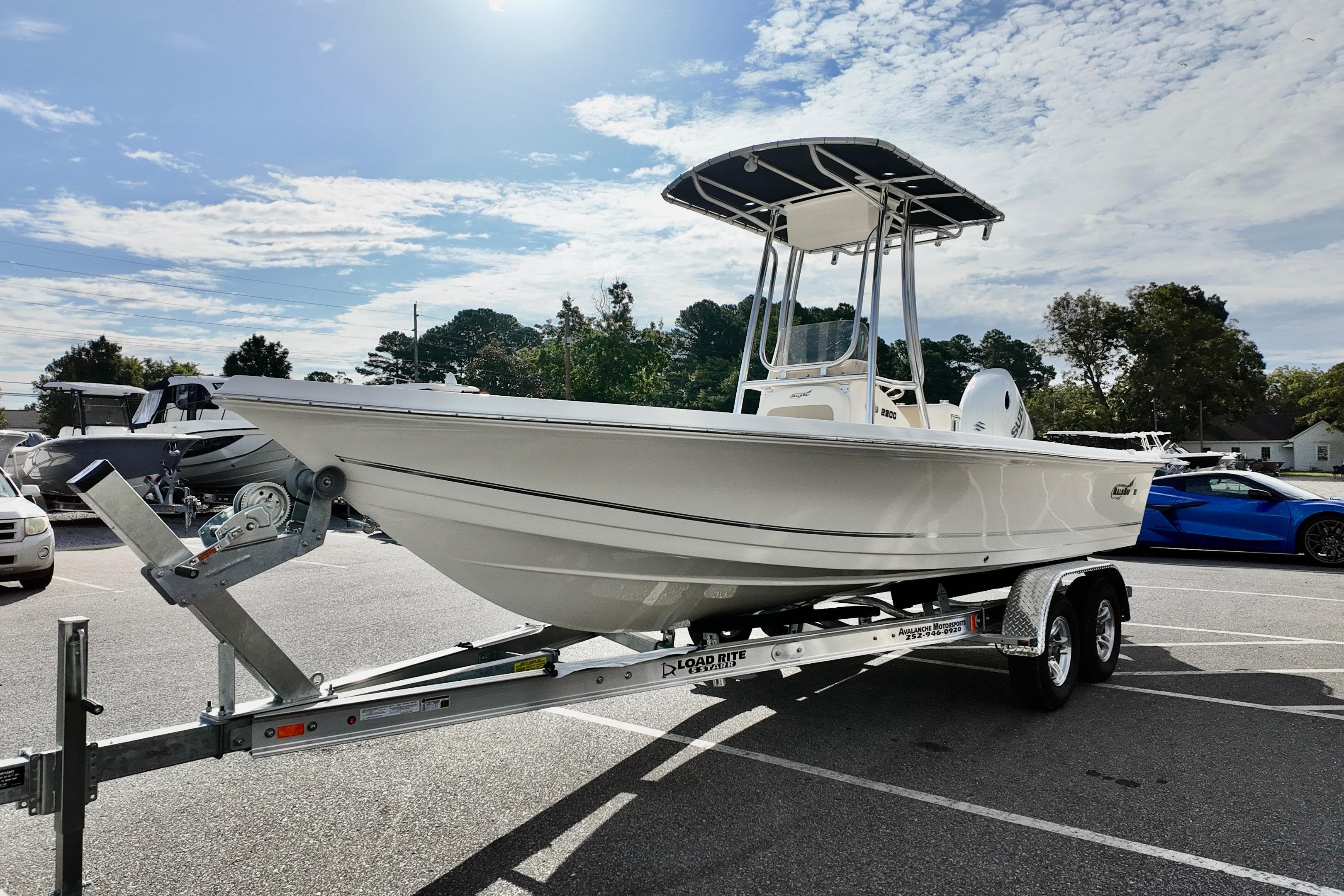 2026 Bulls Bay 2200 boat on trailer in parking lot under sunny sky.