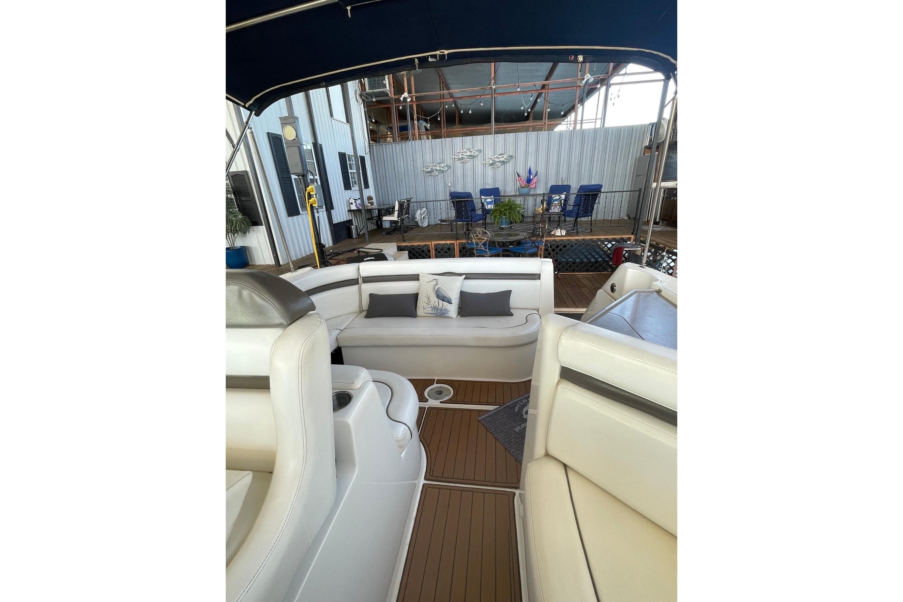 2008 Rinker 350 Express Cruiser interior with white seating and outdoor view.