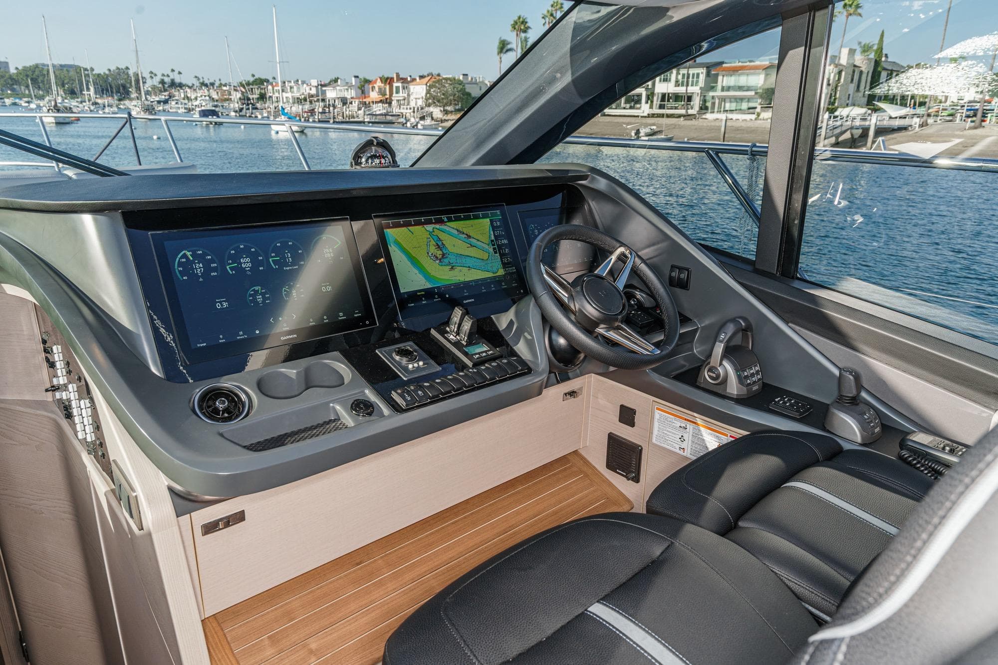 Interior cockpit of 2026 Princess V55 yacht with advanced navigation displays.