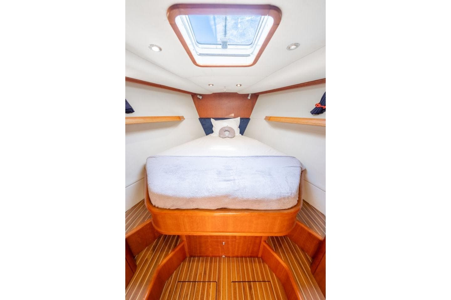Luxurious cabin interior of 2008 Discovery 55 yacht with skylight and wooden accents.