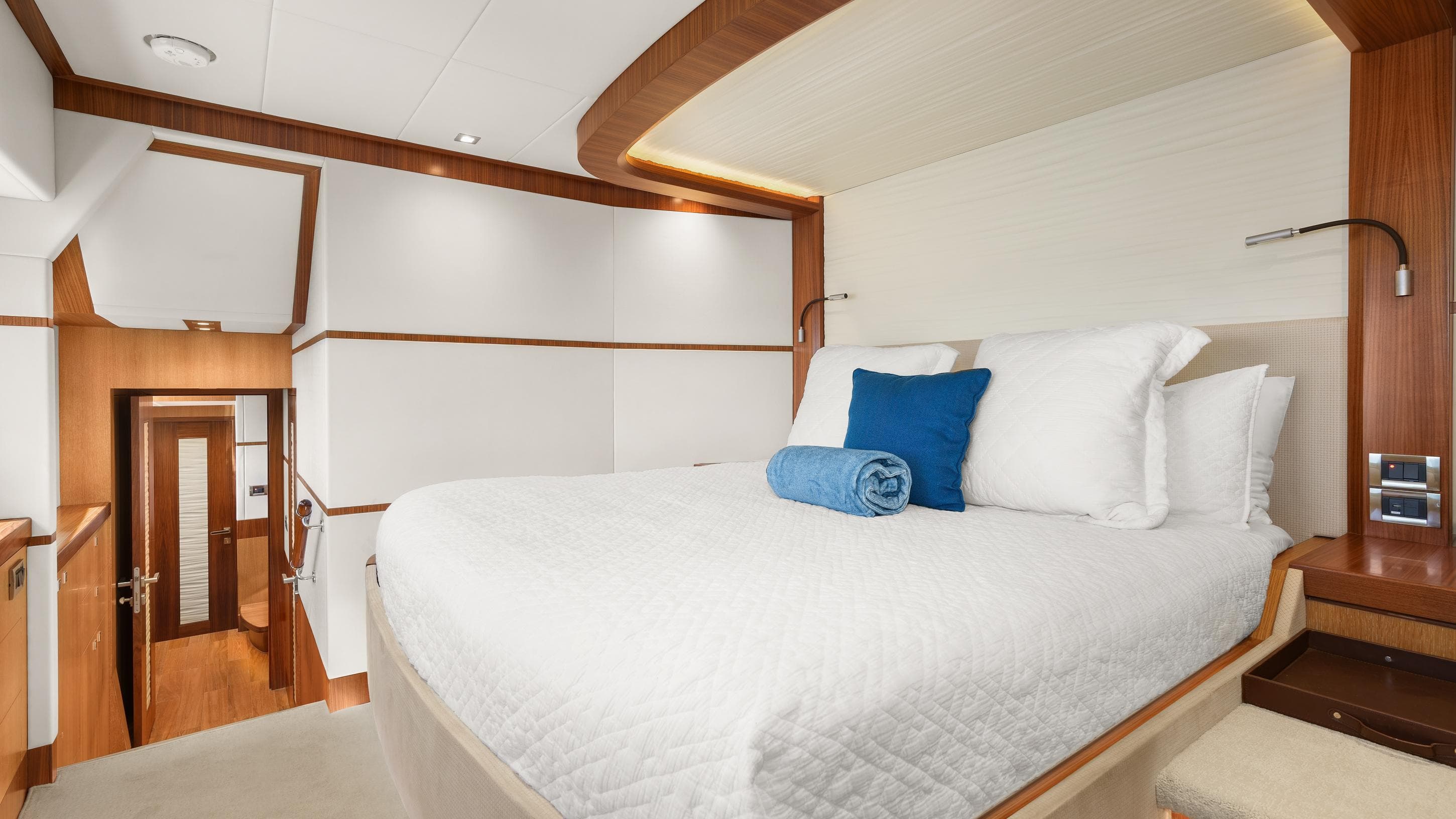 Luxurious bedroom interior on 2018 Horizon PC74 yacht with modern design and cozy bedding.