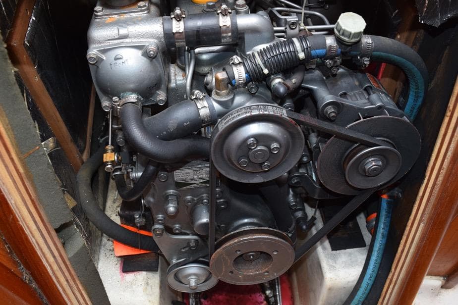 Engine of a 2001 Hunter 340 sailboat, showcasing belts and hoses.