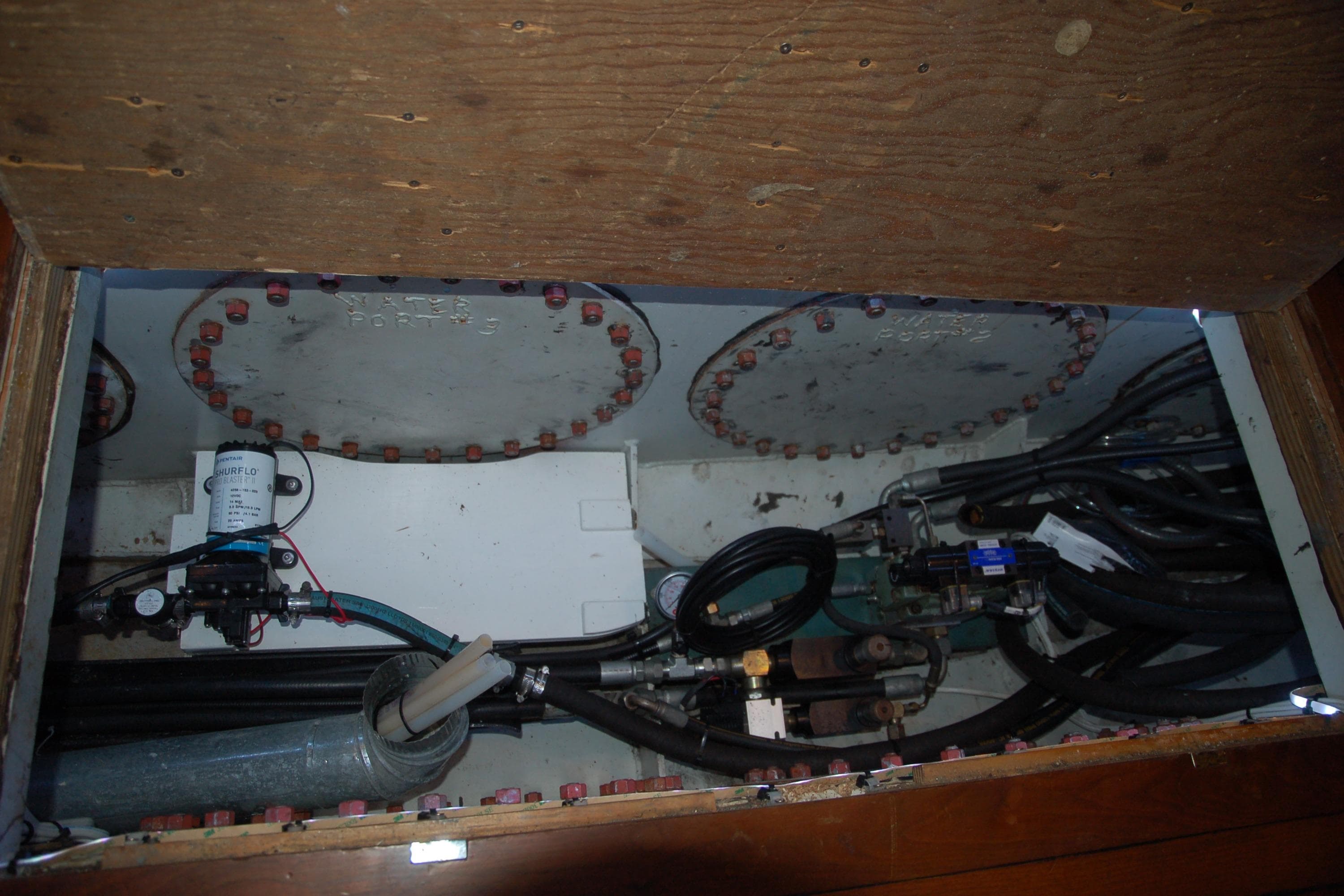 Custom 2006 Sprague model machinery with pipes and valves in a wooden compartment.