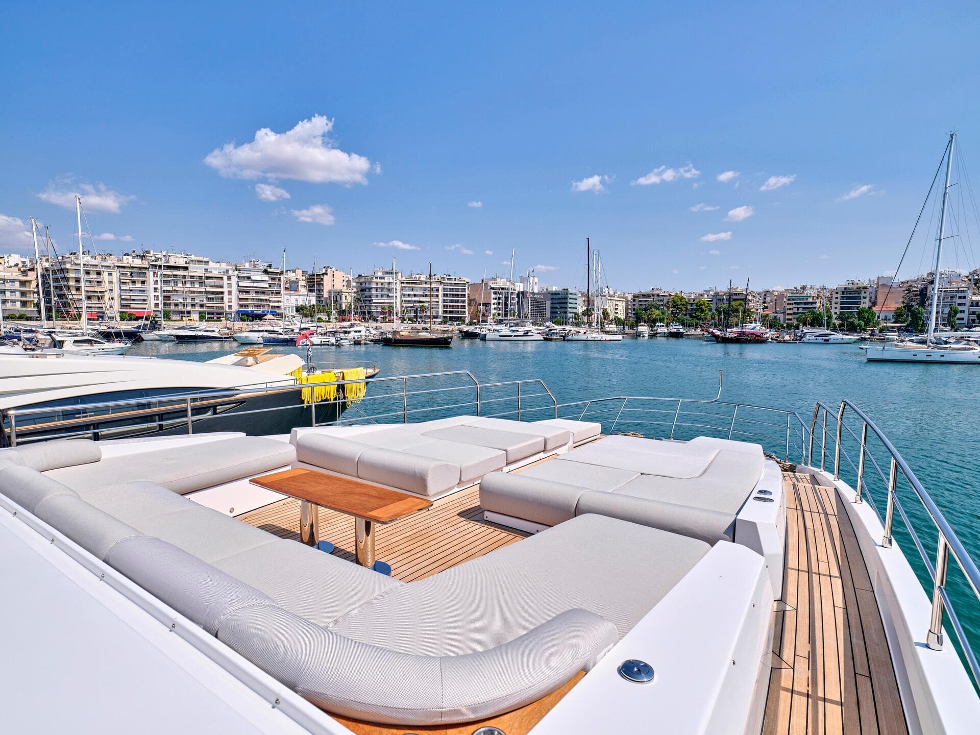 Luxurious 2019 Azimut Grande 32 Metri yacht with spacious deck, docked in a scenic marina.